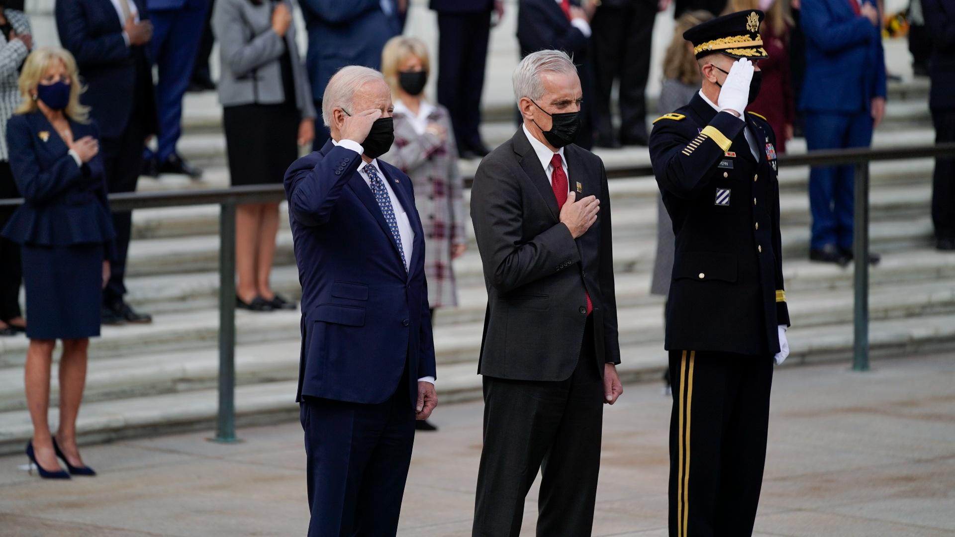 President Joe Biden salutes as he stands with Veterans Affairs Secretary Denis McDonough and Army Maj. Gen. Allan M. Pepin during a wreath laying ceremony to commemorate Veterans Day and mark the centennial anniversary of the Tomb of the Unknown Soldier at Arlington National Cemetery, Thursday, Nov. 11, 2021, in Arlington, Va. First lady Jill Biden is at left. (AP Photo / Evan Vucci)