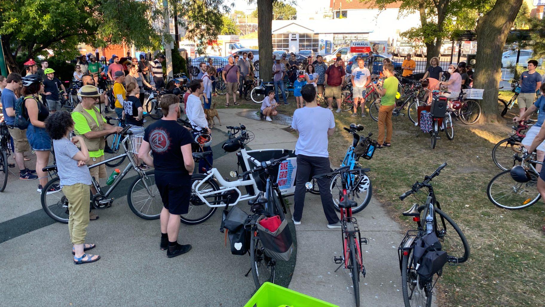 Advocates rally in Roscoe Village’s Fellger Park on Sept. 7, 2022, calling on the city to include more infrastructure upgrades for cyclists, bus passengers, and pedestrians during an upcoming resurfacing of Belmont Avenue. (Nick Blumberg / WTTW News)