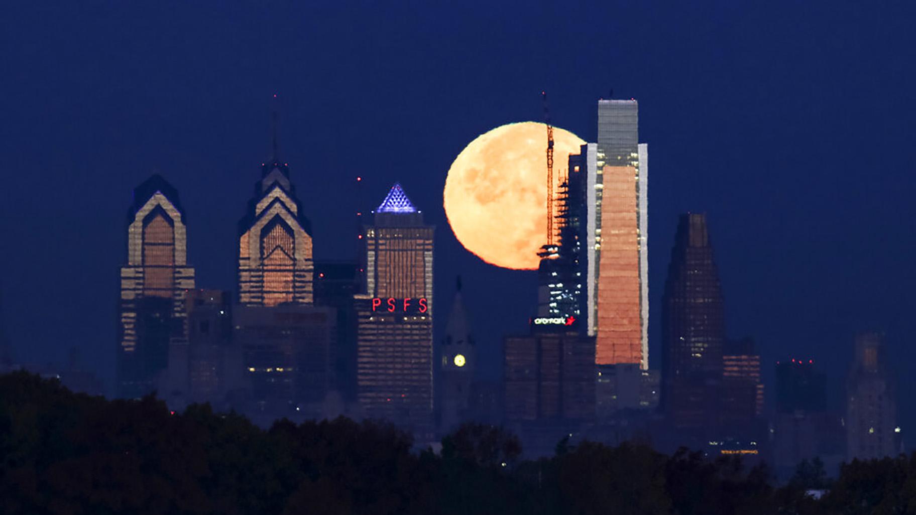 A supermoon sets behind the Philadelphia skyline. Bird Safe Philly announced on Thursday, March 11, 2021, that Philadelphia is joining the national Lights Out initiative, a voluntary program in which as many external and internal lights in buildings are turned off or dimmed at night during the spring and fall bird migration seasons. (AP Photo / Joseph Kaczmarek)