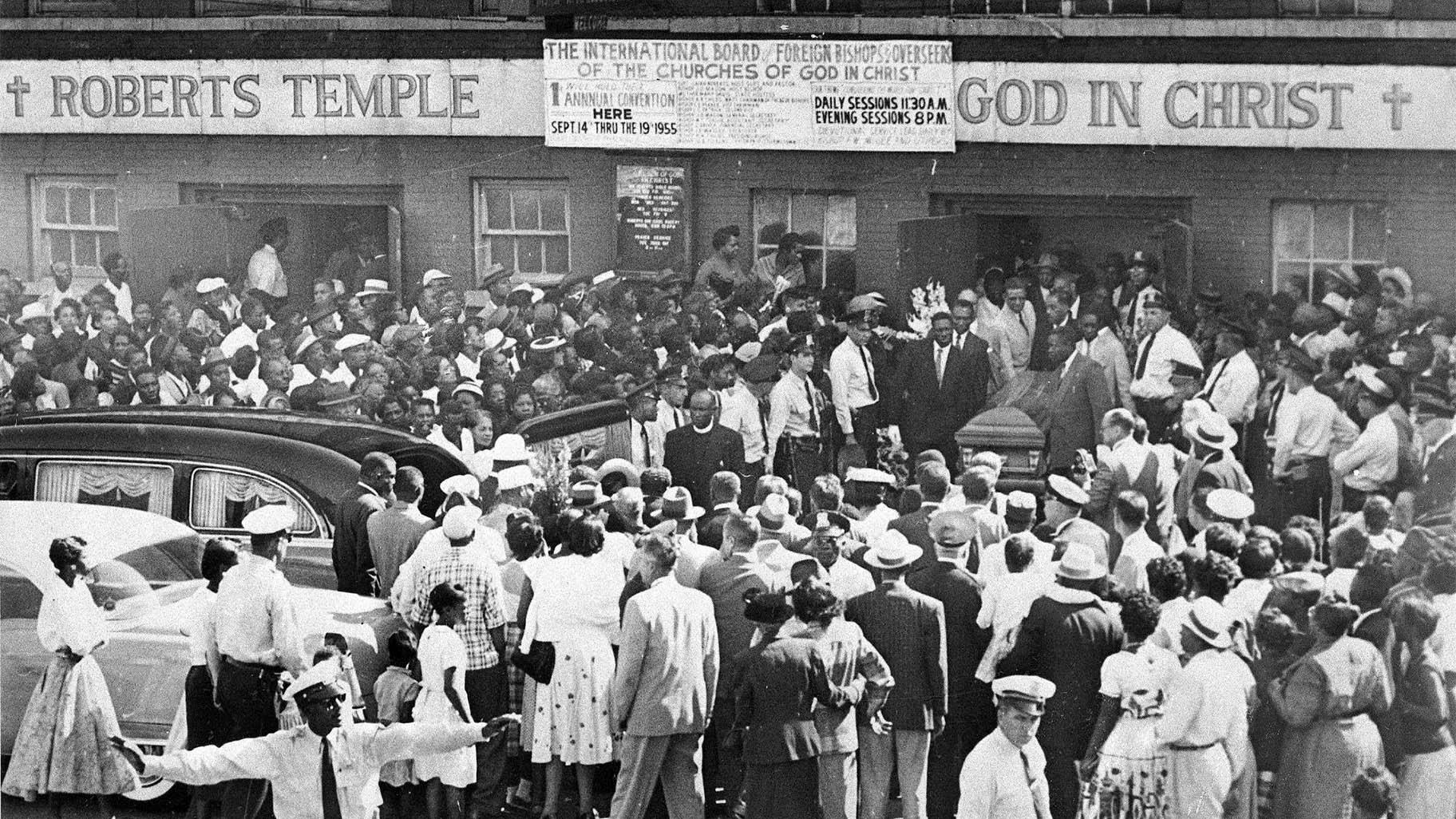 FILE - A large crowd gathers outside the Roberts Temple Church of God In Christ in Chicago, Sept. 6, 1955, as pallbearers carry the casket of Emmett Till, a 14-year-old African-American boy who was slain while on a visit to Mississippi. The African American Cultural Heritage Action Fund is awarding $3 million in grants to help preserve the site and dozens more across the nation. (Chicago Sun-Times via AP)