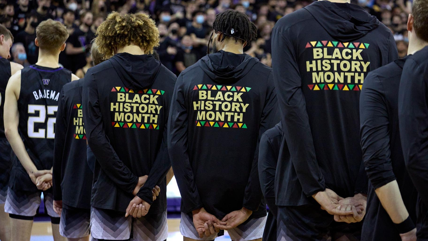 FILE - Washington players stand during the playing of the national anthem wearing warm-up jackets for Black History Month before an NCAA college basketball game against Arizona, Feb. 12, 2022, in Seattle. (John Froschauer / AP Photo, File)