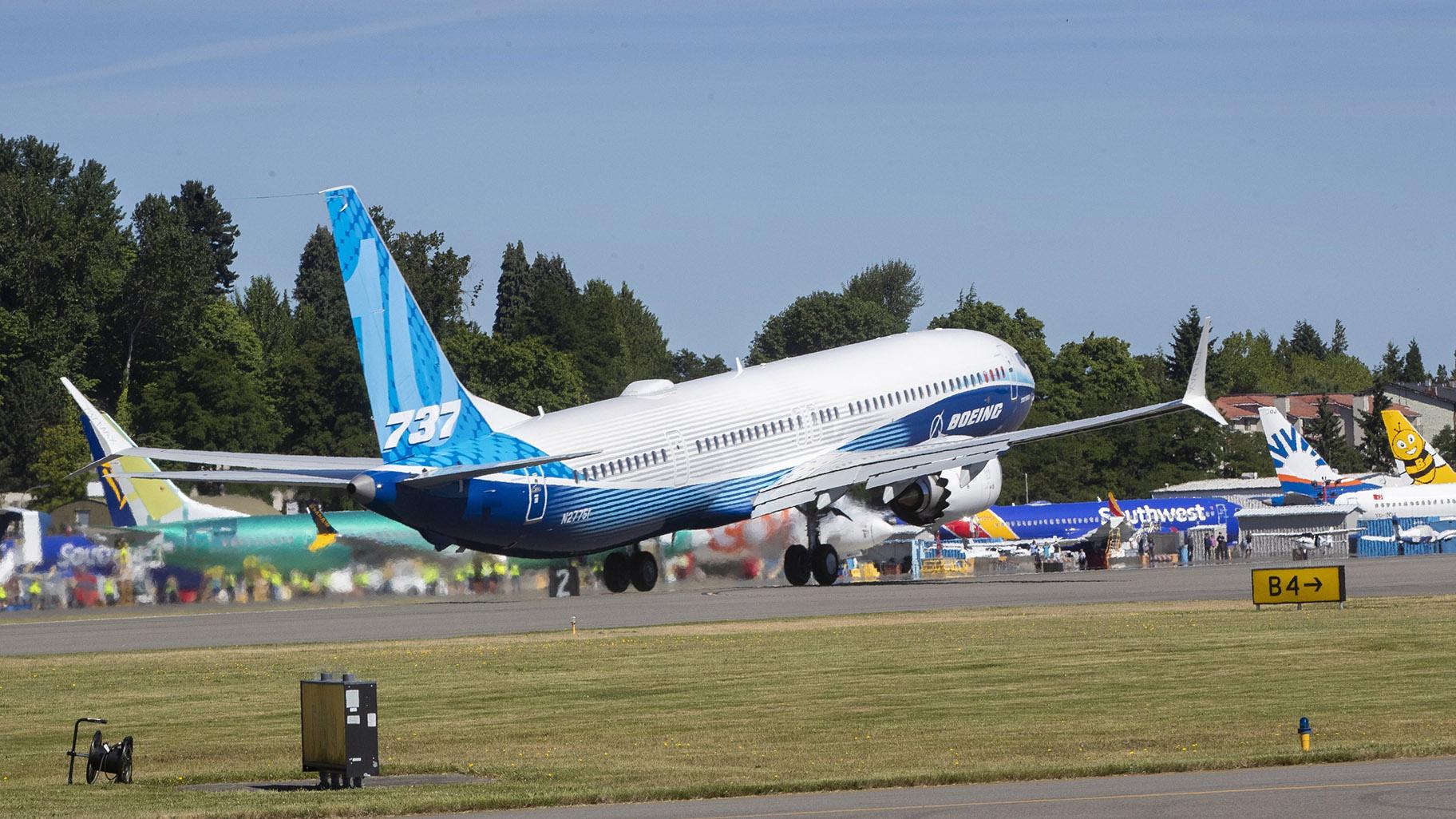 The final version of the 737 MAX, the MAX 10, passes other 737 MAX planes as it takes off from Renton Airport in Renton, Wash., on its first flight Friday, June 18, 2021. The plane will fly over Eastern Washington and then land at Boeing Field. (Ellen M. Banner / The Seattle Times via AP, Pool)