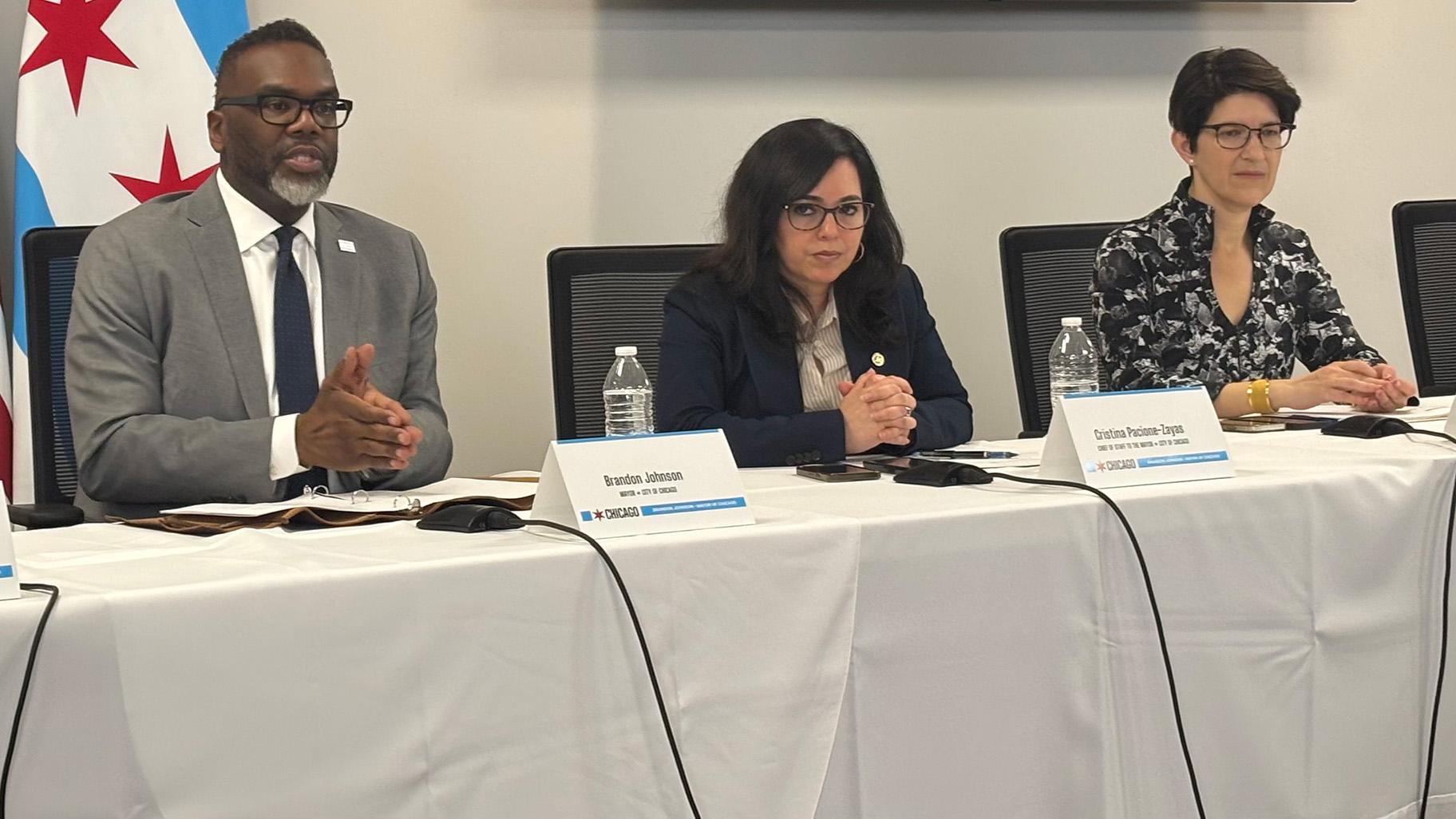Mayor Brandon Johnson addresses the news media on Tuesday, March 18, 2025, alongside Chief of Staff Cristina Pacione Zayas and Chief Financial Officer Jill Jaworski. (Heather Cherone / WTTW News)