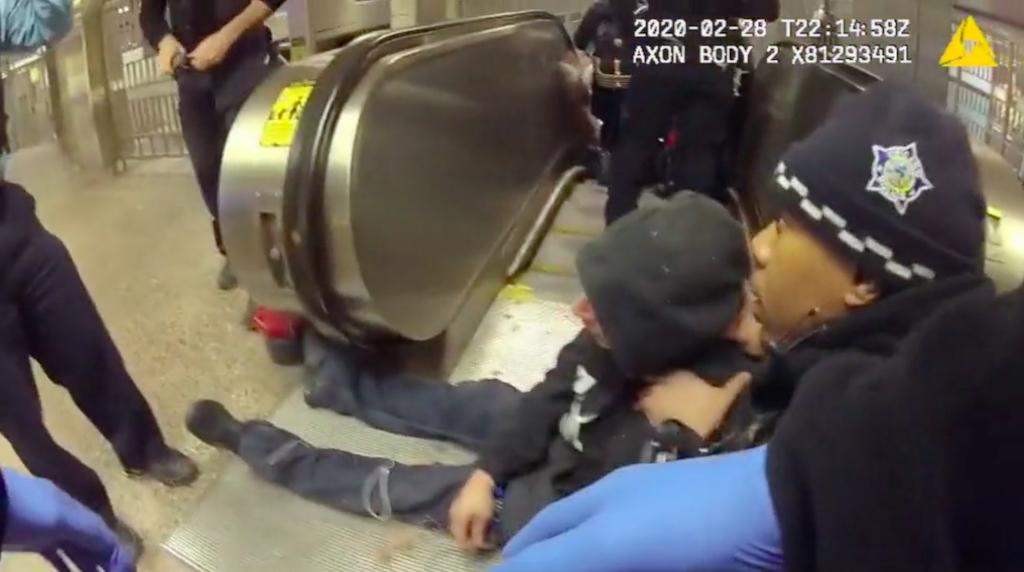 Chicago police officers respond to Ariel Roman, who is seated on the ground moments after he was shot inside the Grand Red Line station on Feb. 28, 2020. (Civilian Office of Police Accountability)