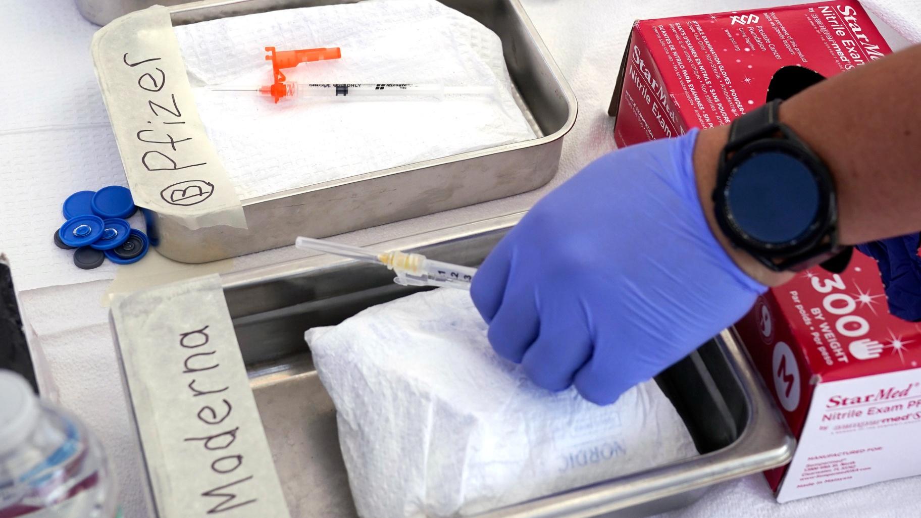 FILE - Syringes with vaccines are prepared at the L.A. Care and Blue Shield of California Promise Health Plans' Community Resource Center where they were offering members and the public free flu and COVID-19 vaccines Oct. 28, 2022, in Lynwood, Calif. (Mark J. Terrill / AP Photo, File)