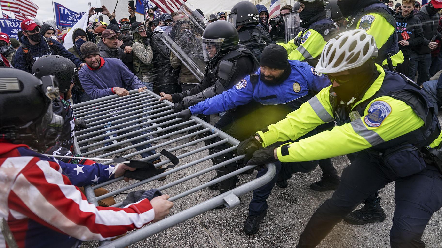 FILE - In this file photo from Wednesday Jan. 6, 2021, Trump supporters beset a police barrier at the Capitol in Washington. (AP Photo / John Minchillo, File)