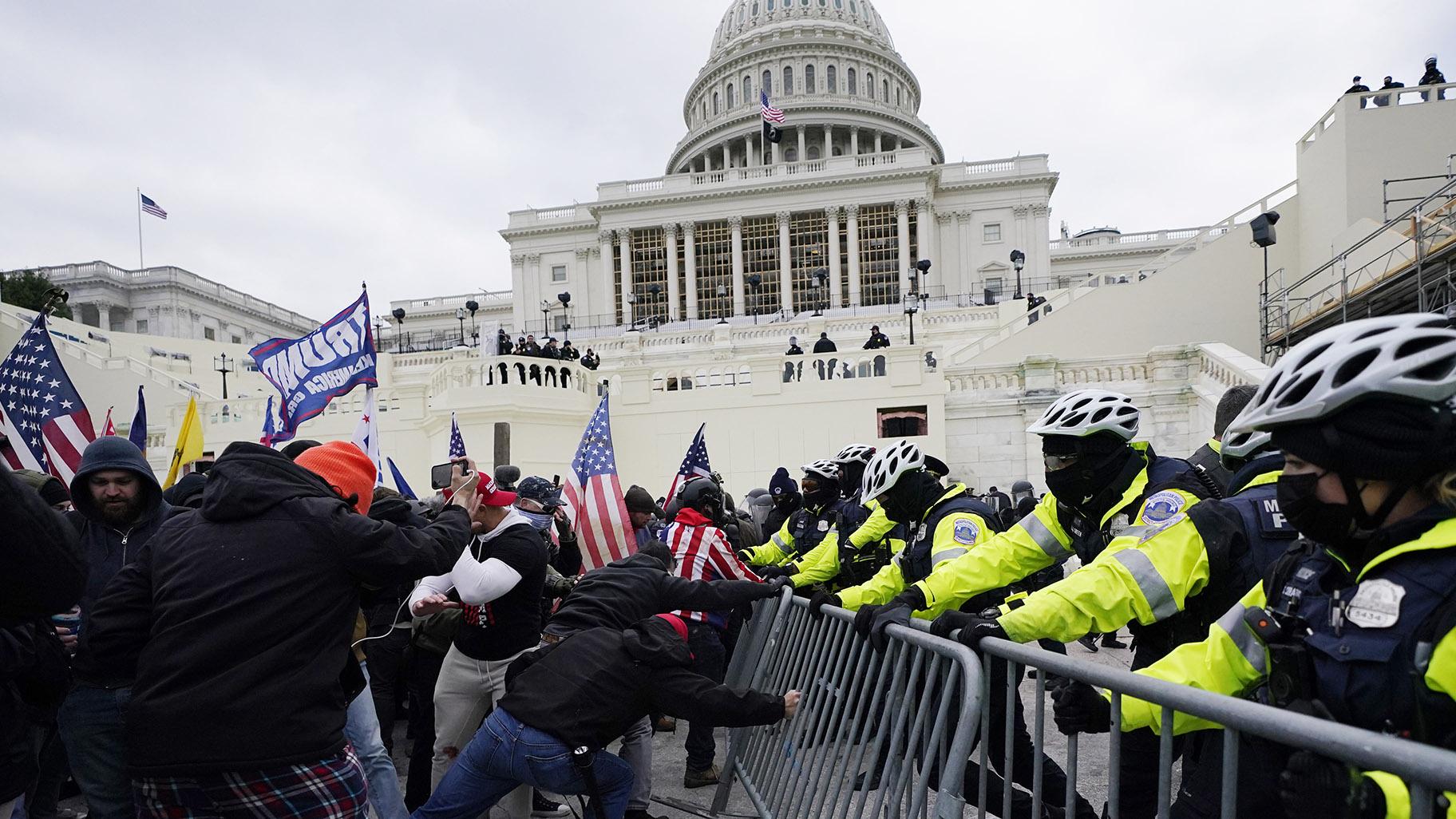 Rioters supporting President Donald Trump try to break through a police barrier at the Capitol in Washington, on Jan. 6, 2021.(AP Photo / Julio Cortez, File)
