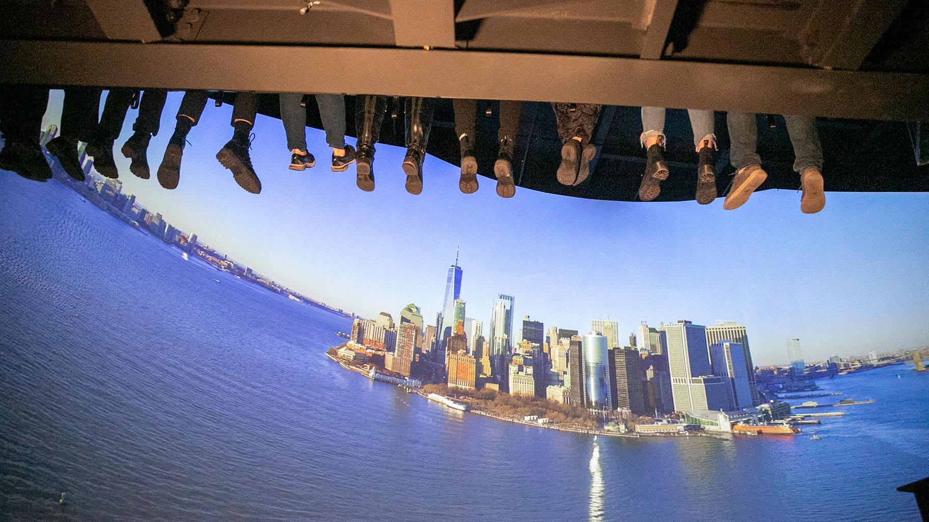 People ride a new indoor tourist attraction called RiseNY just off Times Square in Manhattan’s Theater District in New York City on Tuesday, March 1, 2022. (AP Photo / Ted Shaffrey)