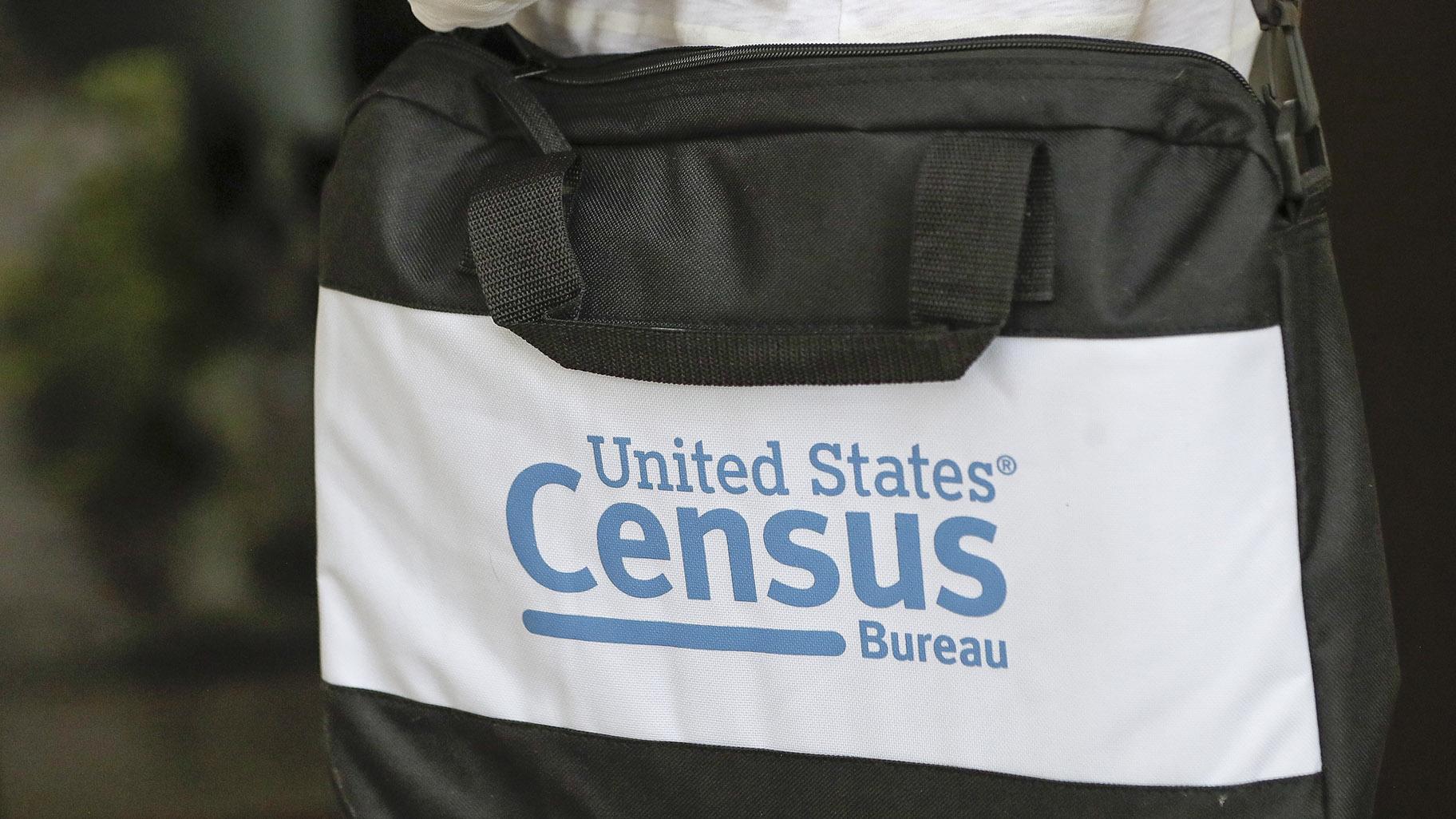 The briefcase of a census taker is seen as she knocks on the door of a residence, Aug. 11, 2020, in Winter Park, Fla. (AP Photo / John Raoux, File)