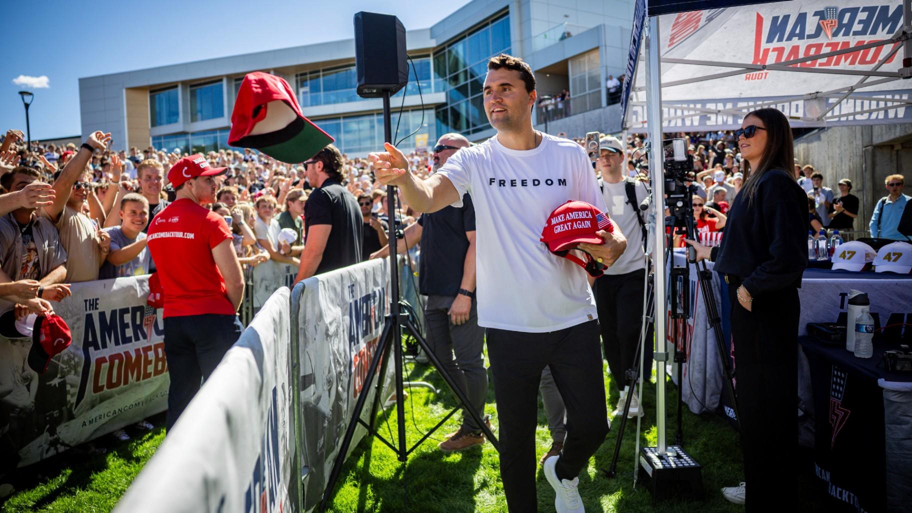 Charlie Kirk hands out hats before speaking at Utah Valley University in Orem, Utah, Wednesday, Sept. 10, 2025. (Tess Crowley/The Deseret News via AP)