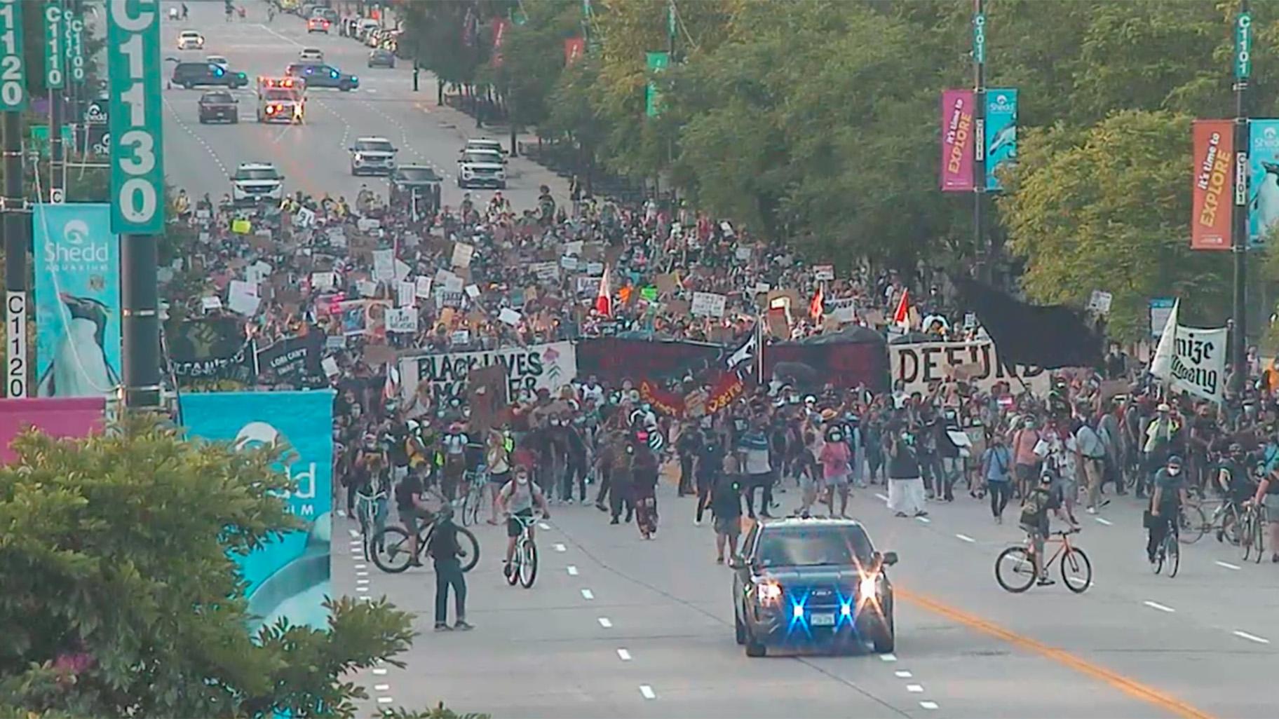 Surveillance footage released by the Chicago Police Department shows protesters marching toward the Christopher Columbus statue on July 17, 2020 evening. (Chicago Police Department)
