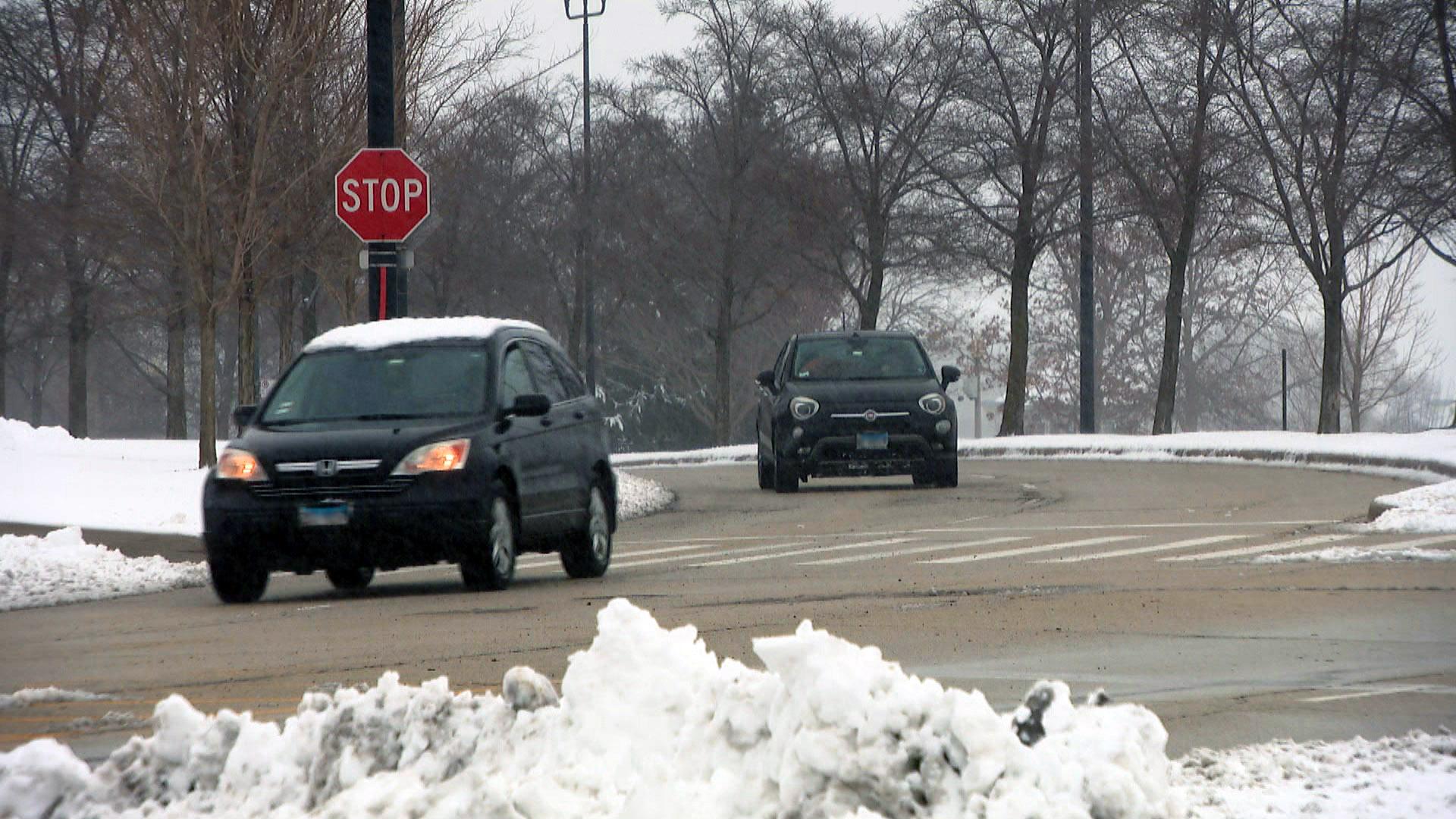 Cars drive on cleared roads in Chicago on Tuesday, Jan. 26, 2021 after the season’s first big snowfall. The city is gearing up for another major storm on Saturday, Jan. 30. (WTTW News)