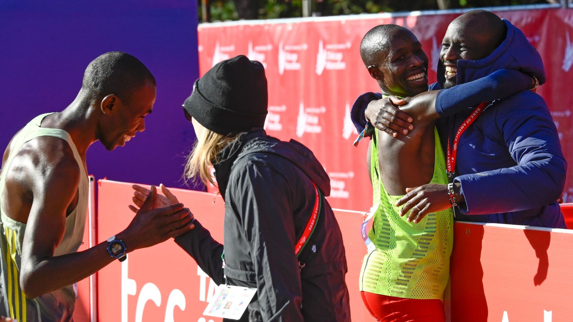 Benson Kipruto, left, and John Korir, second from right, both of Kenya, celebrate after they ran the Chicago Marathon, Sunday, Oct. 9, 2022, in Chicago. Kipruto took first place and Korir took third. (AP Photo / Matt Marton)