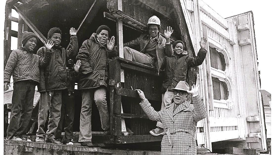 Bishop Louis Henry Ford and neighborhood children with the cupola of the Clarke House as the building was moved in 1977. (Courtesy of the Saint Paul Church of God's archives)