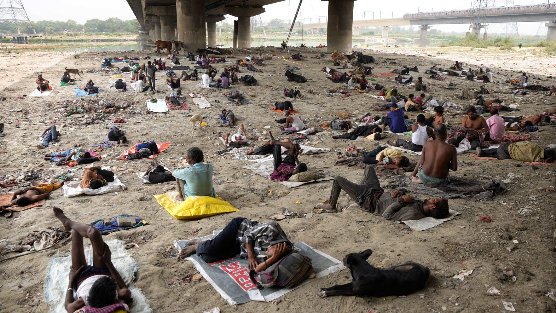 Homeless people sleep in the shade of a bridge on a hot day in New Delhi, May 20, 2022. (AP Photo / Manish Swarup, File)
