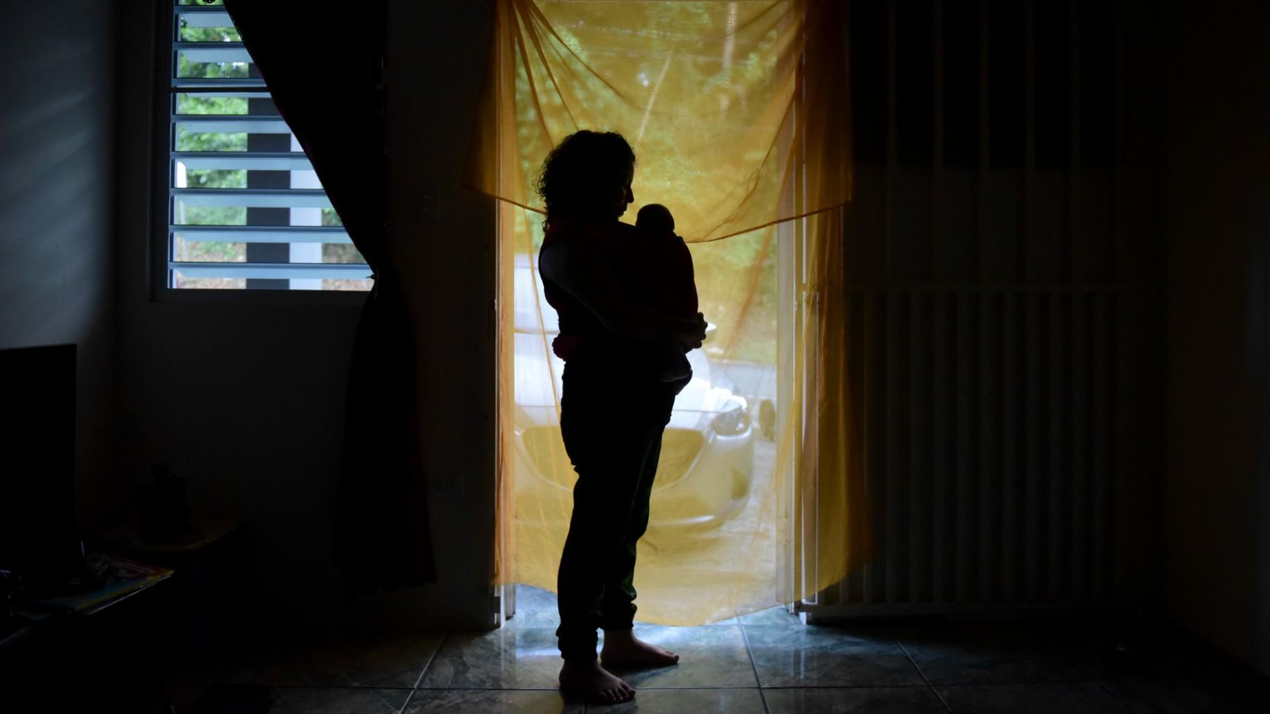 Michelle Flandez stands in her home with her two-month-old son Inti Perez, woh is diagnosed with microcephaly linked to the mosquito-borne Zika virus, in Bayamon, Puerto Rico on Dec. 16, 2016. (AP Photo / Carlos Giusti, File)