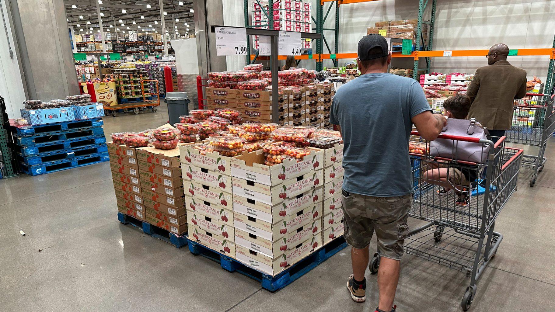 Shoppers peruse a display of Rainer cherries at a Costco warehouse Tuesday, July 11, 2023, in Sheridan, Colo. On Friday, The Commerce Department issues its June report on consumer spending. (David Zalubowski / AP Photo)