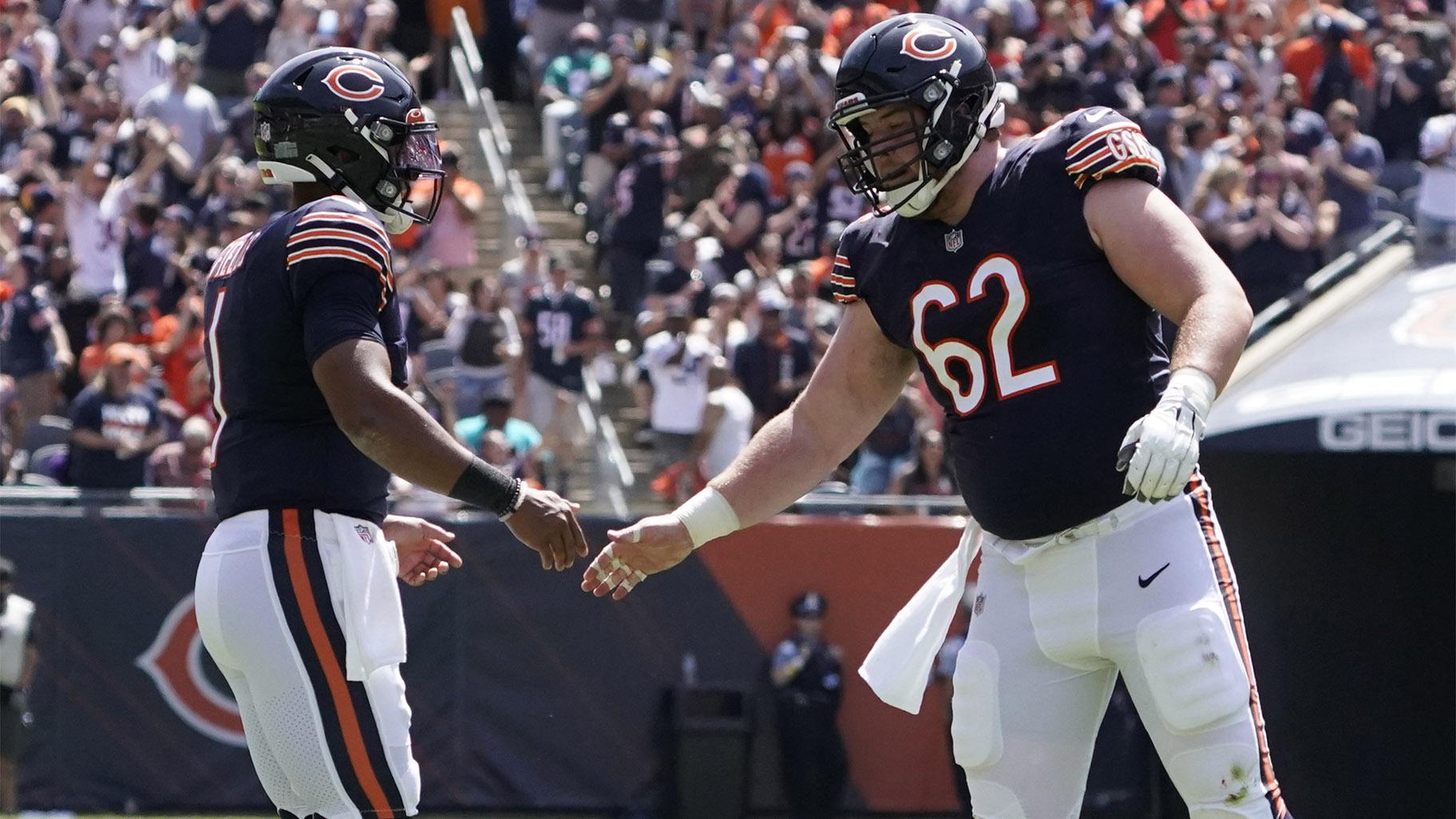 Chicago Bears quarterback Justin Fields, left, is congratulated by Adam Redmond (62) after throwing a touchdown pass against the Miami Dolphins during the second half of an NFL preseason football game in Chicago, Saturday, Aug. 14, 2021. (AP Photo  /David Banks)