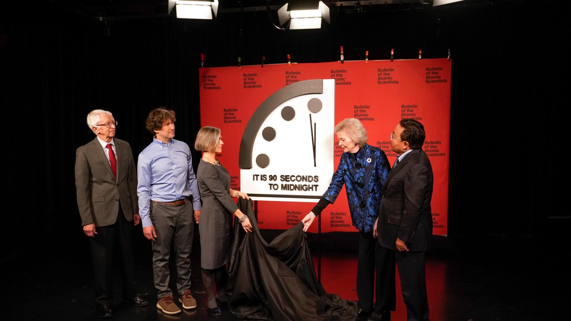Siegfried Hecker, from left, Daniel Holz, Sharon Squassoni, Mary Robinson and Elbegdorj Tsakhia with the Bulletin of the Atomic Scientists, remove a cloth covering the Doomsday Clock before a virtual news conference at the National Press Club in Washington, Tuesday, Jan. 24, 2023. (AP Photo / Patrick Semansky)