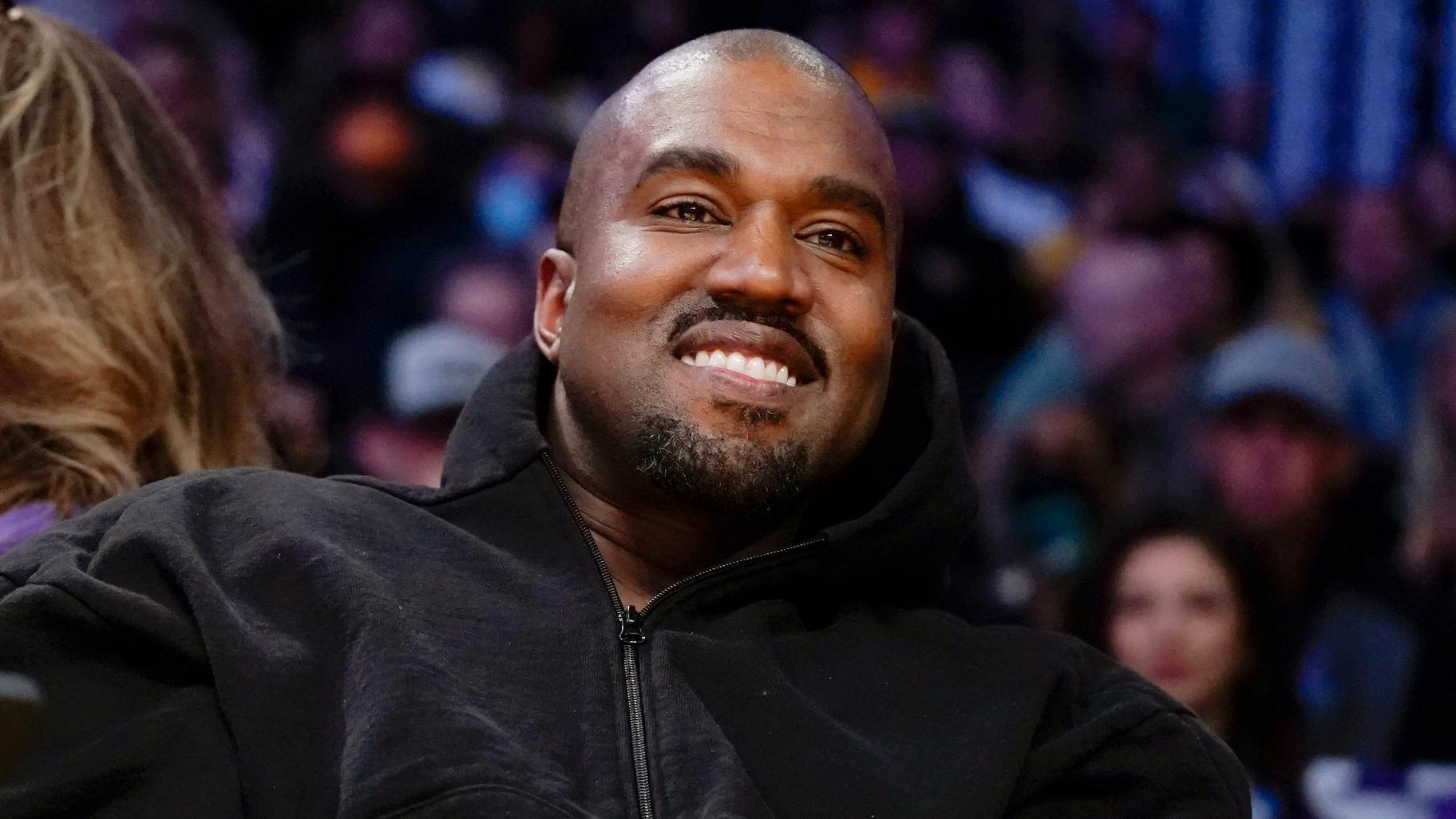 Kanye West watches the first half of an NBA basketball game between the Washington Wizards and the Los Angeles Lakers in Los Angeles, on March 11, 2022. (AP Photo / Ashley Landis, File)