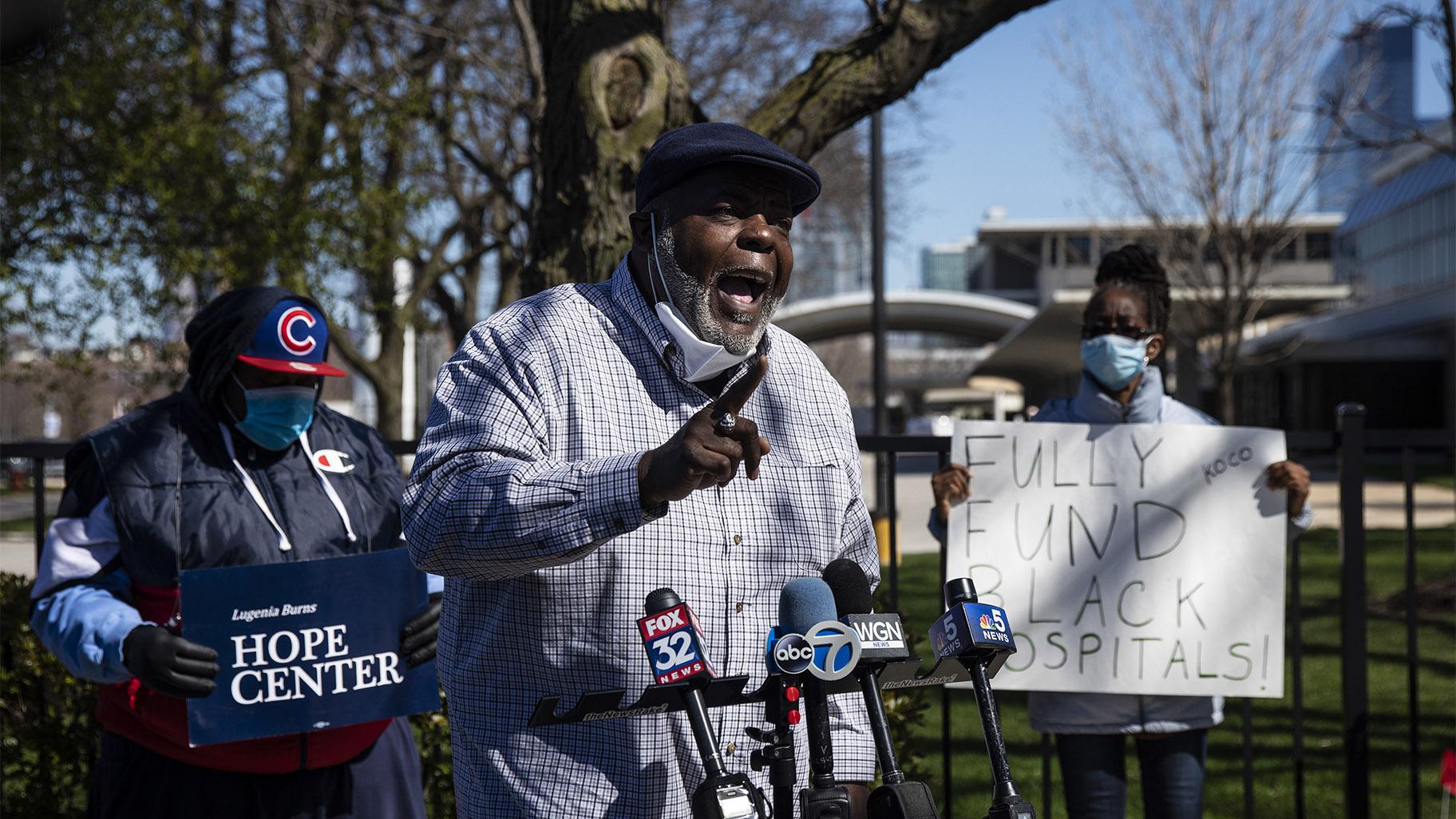 FILE - In this April 20, 2020 file photo, Jitu Brown, national director for the Journey for Justice Alliance, speaks to reporters outside Mercy Hospital & Medical Center in Chicago. Brown said school closures and other city policies have disproportionately affected people of color and contributed to Chicago's loss of Black residents. (Ashlee Rezin Garcia / Chicago Sun-Times via AP) 