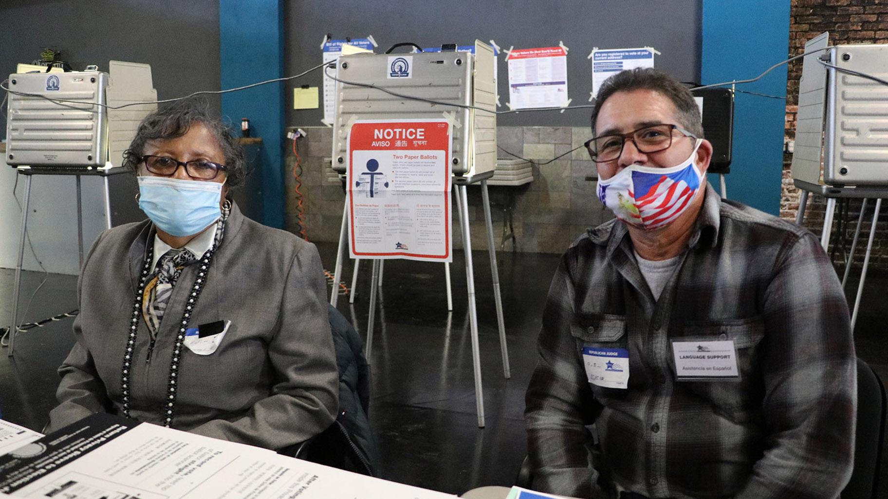 Poll workers Janice Meeks and Marco Rivera at El Mexico Moderno Ballroom in West Humboldt Park on Election Day, Nov. 3, 2020. (Evan Garcia / WTTW News)