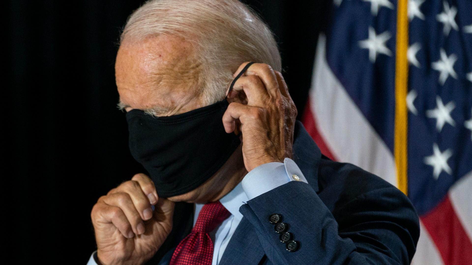 Democratic presidential candidate former Vice President Joe Biden joined by his running mate Sen. Kamala Harris, D-Calif., replaces his face mask after speaking at the Hotel DuPont in Wilmington, Del., Thursday, Aug. 13, 2020. (AP Photo / Carolyn Kaster)