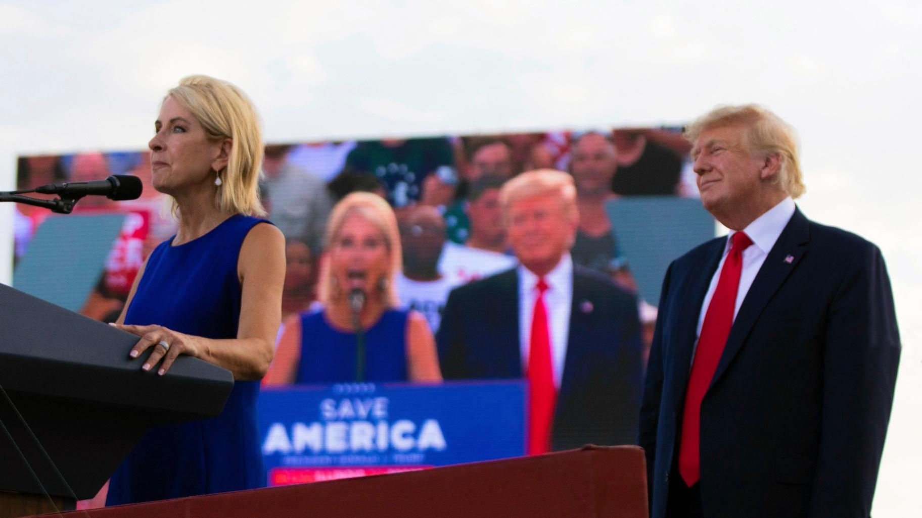 U.S. Rep. Mary Miller, of Illinois, speaks as former President Donald Trump stands behind her on stage at a rally at the Adams County Fairgrounds in Mendon, Ill., Saturday, June 25, 2022. (Mike Sorensen / Quincy Herald-Whig via AP)