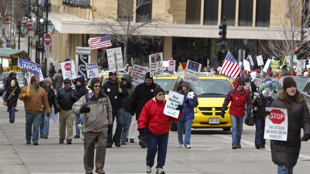Pro-union protesters march around the the Wisconsin state Capitol in Madison, Wis., March 26, 2011. With U.S. union ranks swelling as everyone from coffee shop baristas to warehouse workers seeks to organize, Illinois voters will decide in November 2022 whether to amend their state constitution to guarantee the right to bargain collectively. (AP Photo/Andy Manis, File)