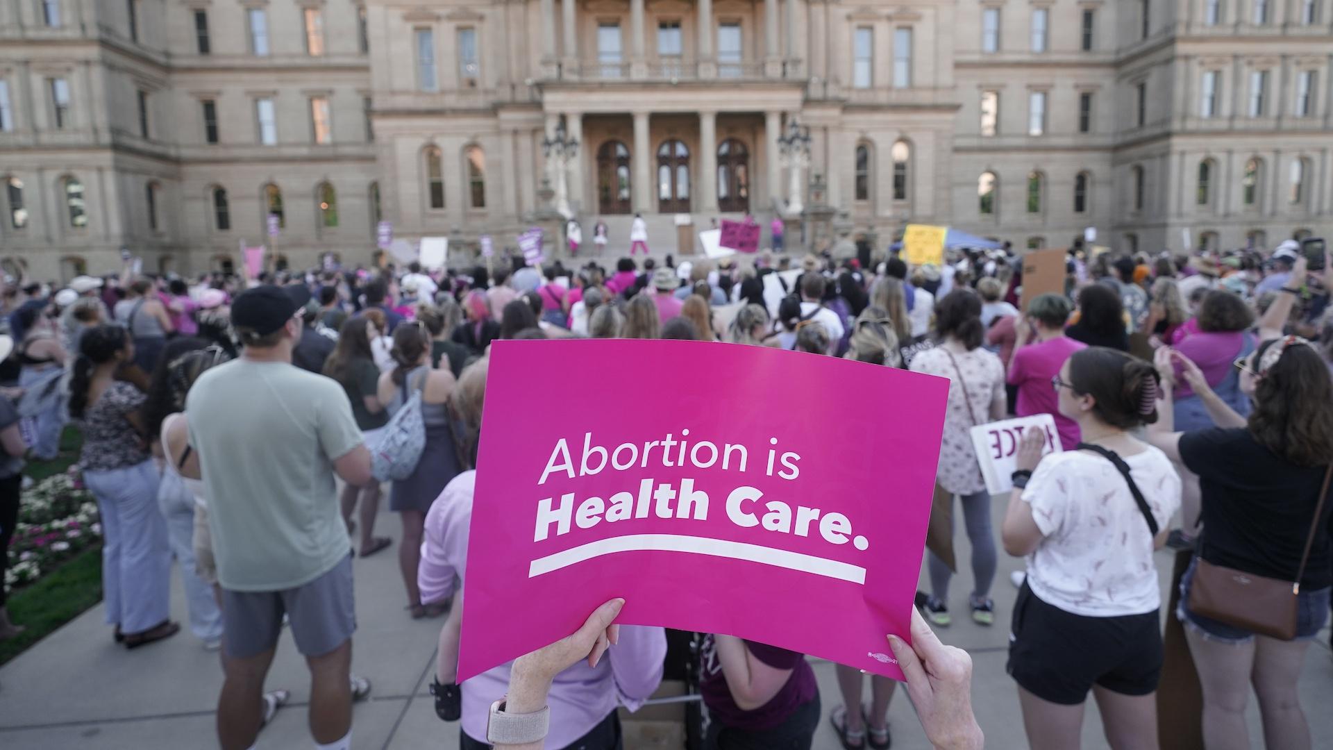 Abortion-rights protesters attend a rally following the United States Supreme Court's decision to overturn Roe v. Wade, the federally protected right to abortion, outside the state capitol in Lansing, Mich., Friday, June 24, 2022. (AP Photo/Paul Sancya, File)