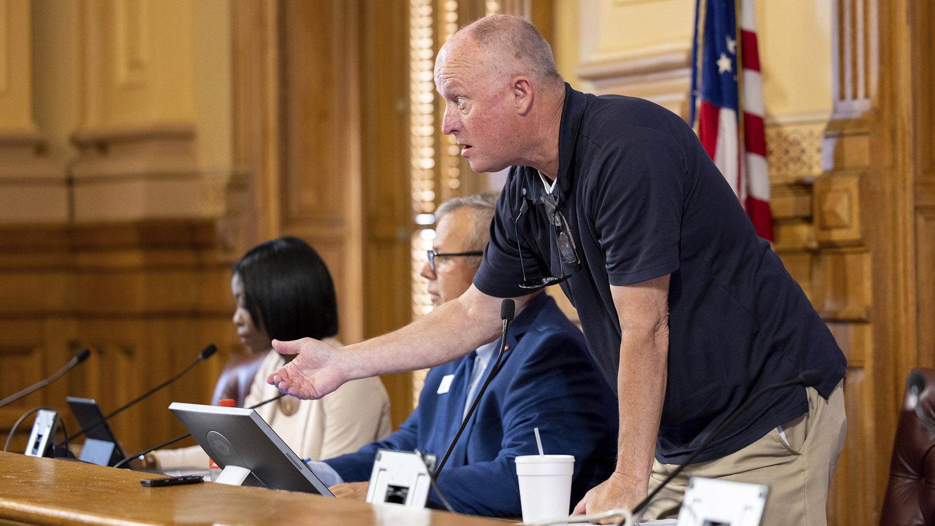 State Election Board member Rick Jeffares asks the crowd to settle down during a hastily planned State Election Board meeting at the Capitol in Atlanta, July 12, 2024. (Arvin Temkar / Atlanta Journal-Constitution via AP, File)