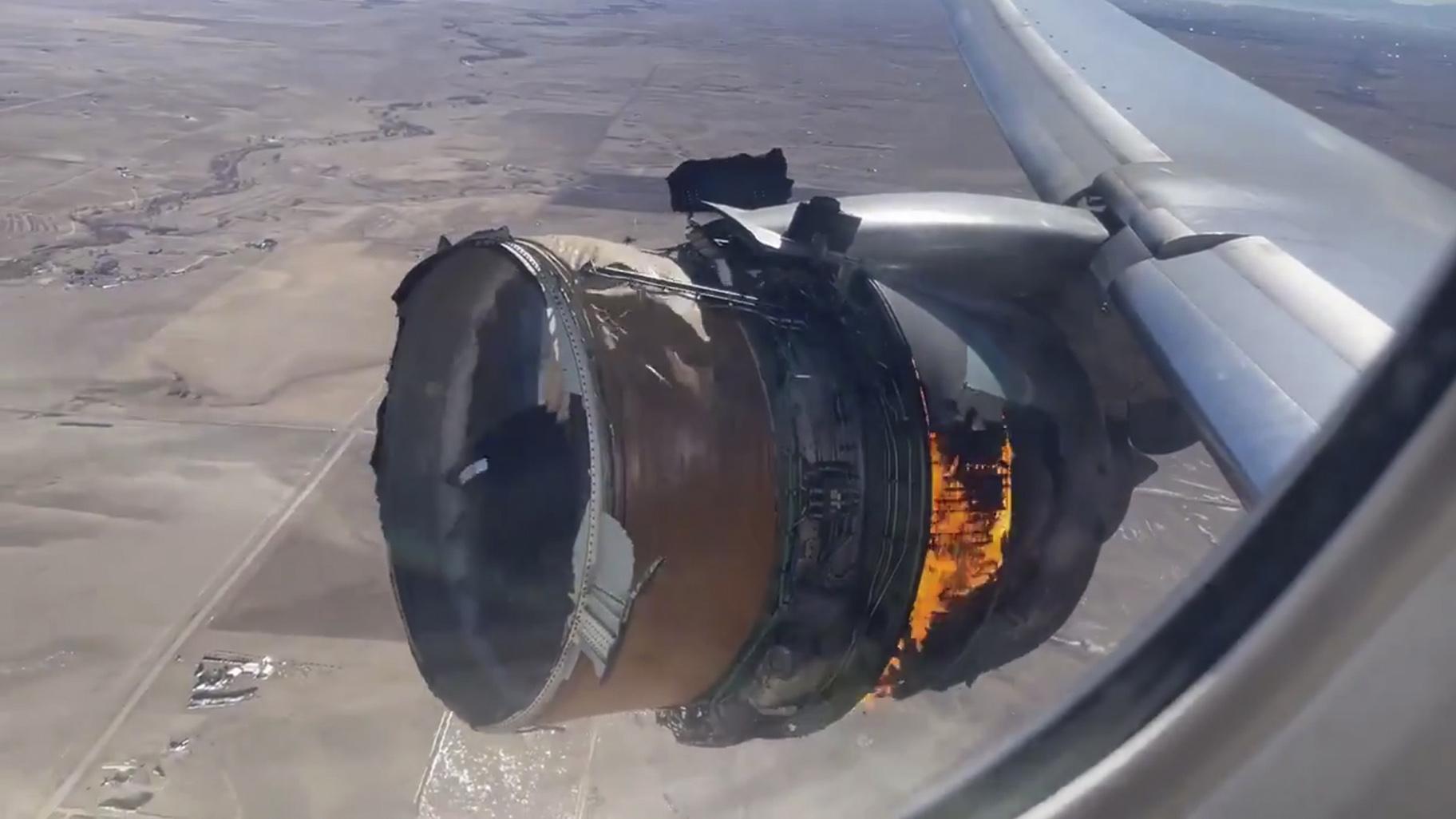 In this file photo taken from video, the engine of United Airlines Flight 328 is on fire after experiencing "a right-engine failure" shortly after takeoff from Denver International Airport, Saturday, Feb. 20, 2021, in Denver, Colo. Two passengers who were on board the United Airlines airplane that had to make an emergency landing are suing the company in separate suits filed Friday, April 16 in Chicago, where United is based. (Chad Schnell via AP, File)