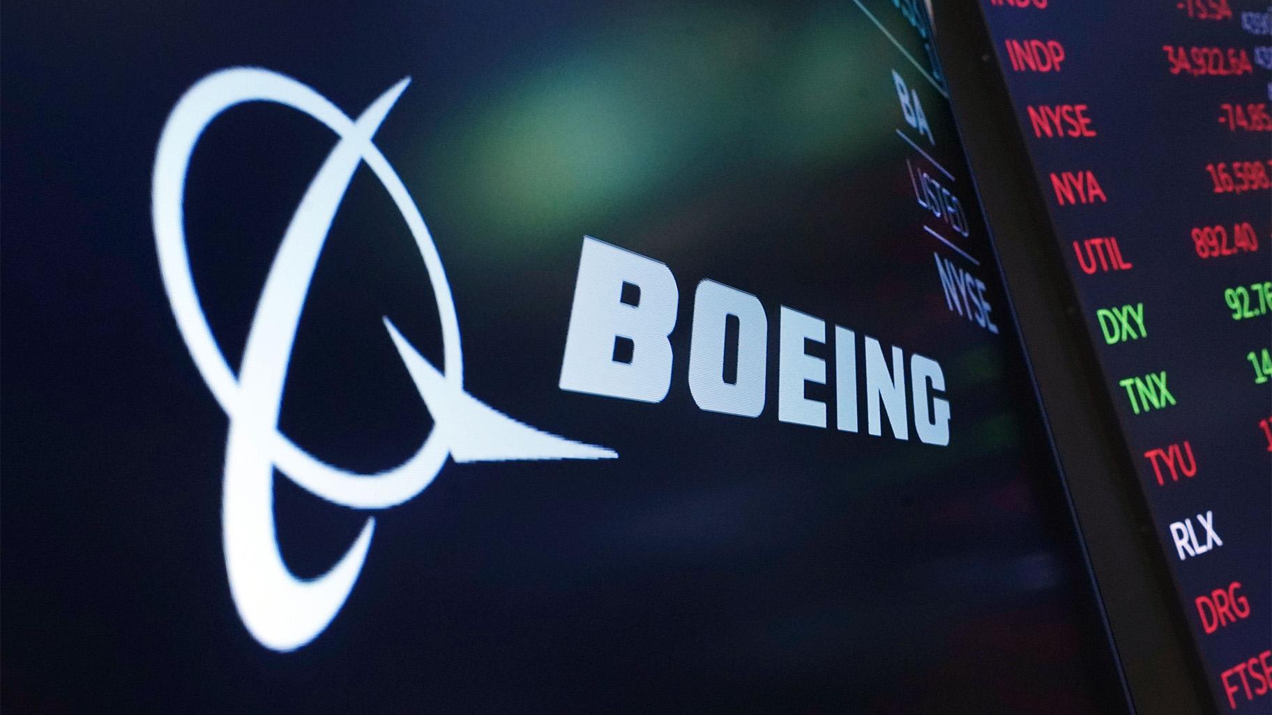 The logo for Boeing appears on a screen above a trading post on the floor of the New York Stock Exchange, Tuesday, July 13, 2021. (AP Photo / Richard Drew, file)