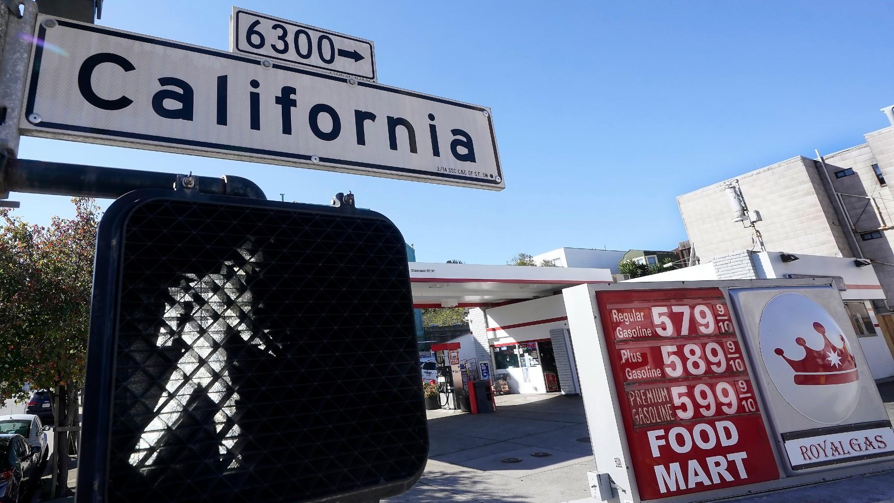 A California street sign is shown next to the price board at a gas station in San Francisco, on March 7, 2022. (AP Photo / Jeff Chiu, File)