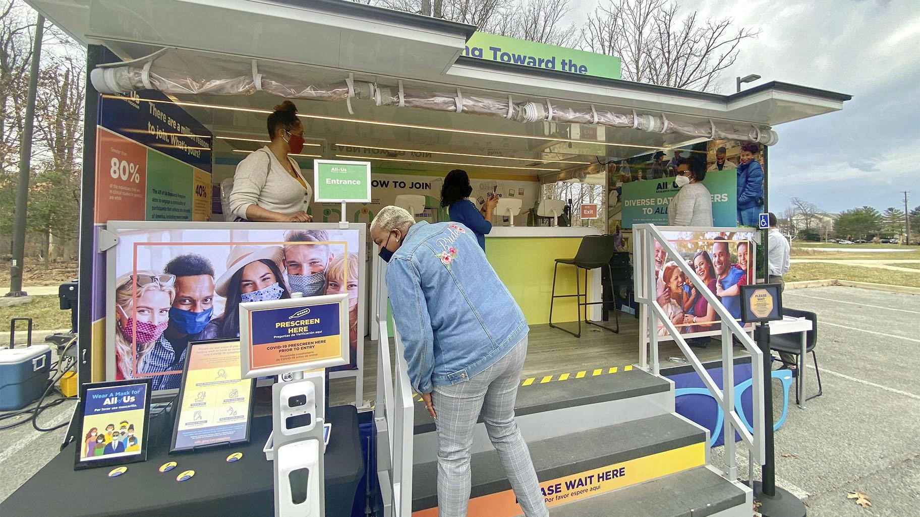In this photo provided by the National Institute of Health’s “All of Us” research program, people visit a study vehicle in Silver Spring, Md. on March 8, 2022. (Dianne Beltran / All of Us Research Program via AP)