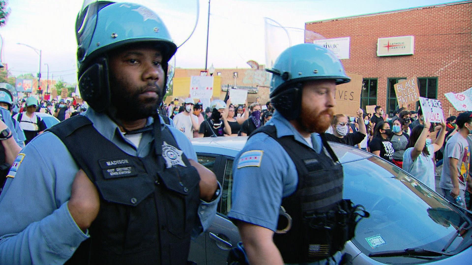 Chicago police officers and demonstrators make their way along city streets during one of many protests sparked by the 2020 police killing of George Floyd. (WTTW News)