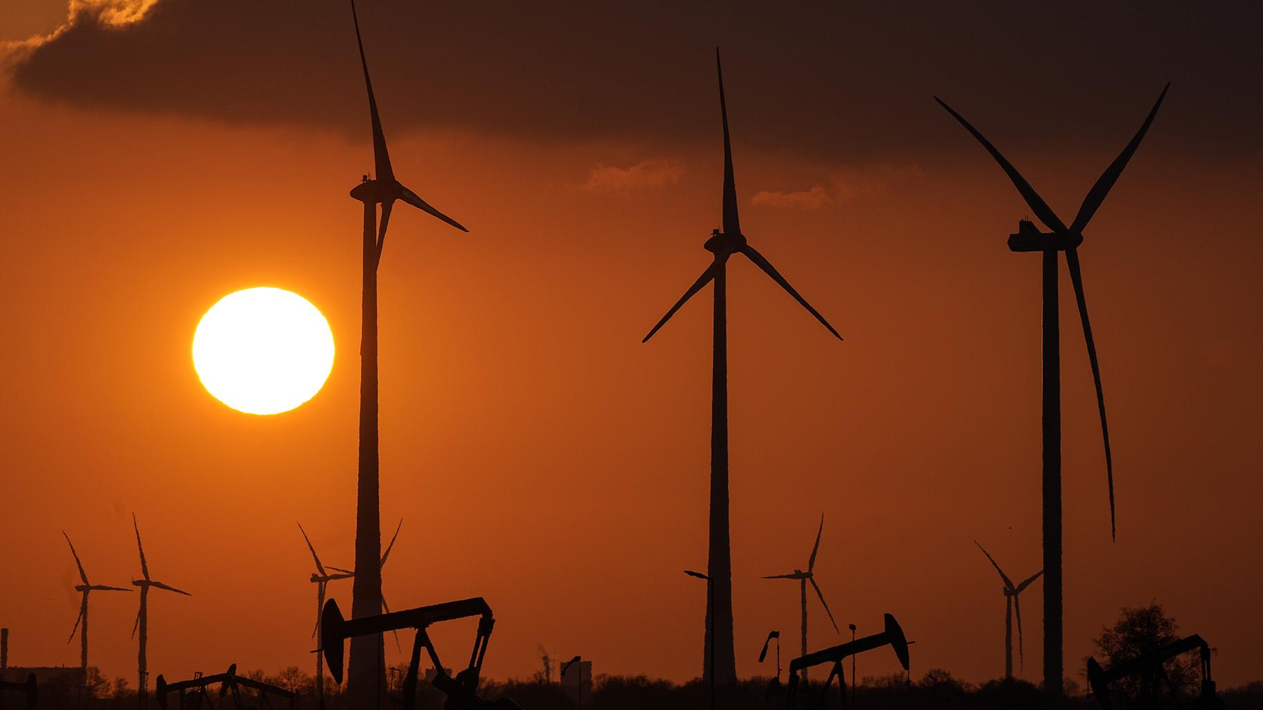 Wind turbines produce power during sundown in Emlichheim, Germany, Friday, March 18, 2022. (AP Photo / Martin Meissner, file)
