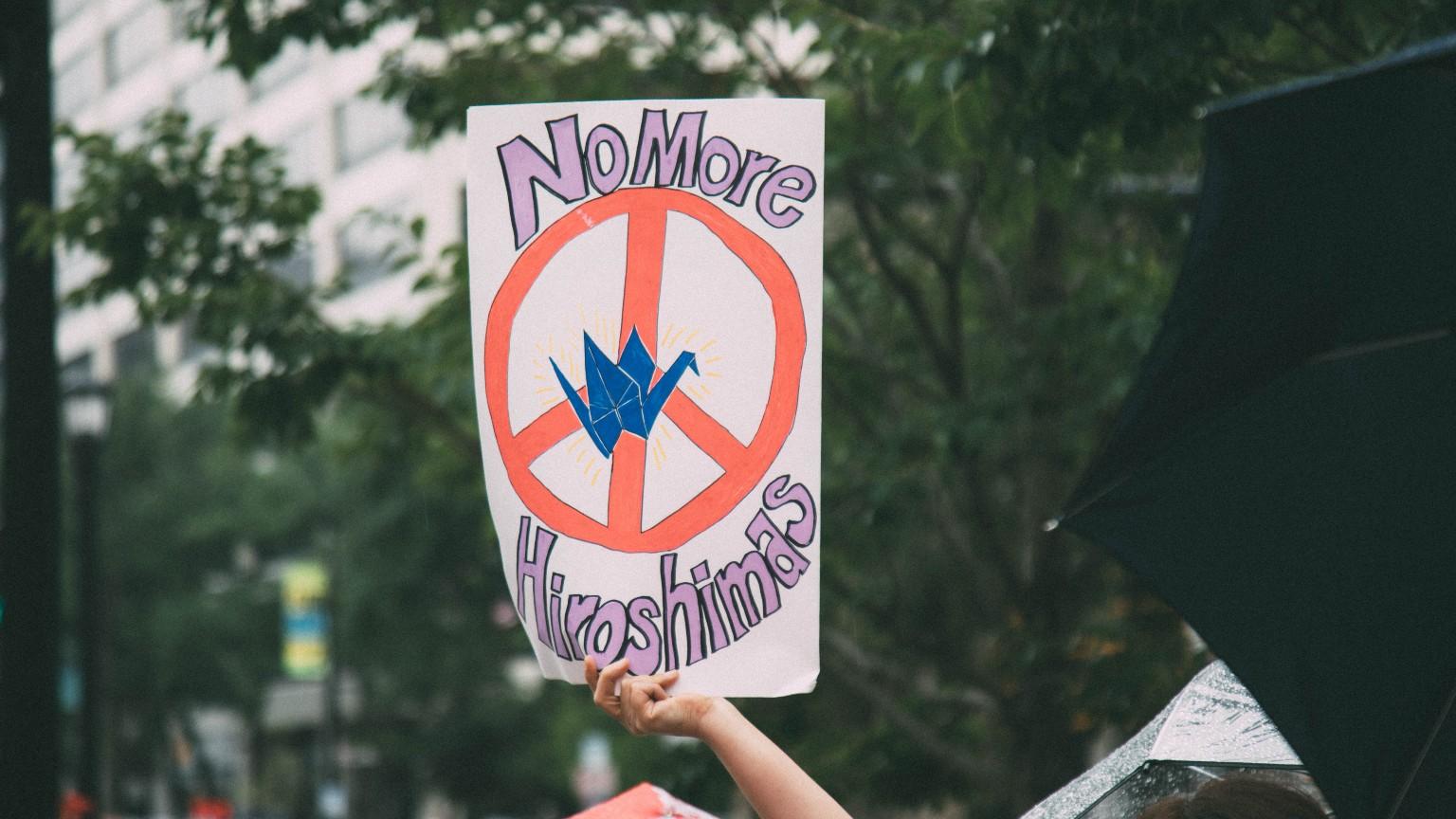 A participant holds up a sign during a peace rally held in Evanston on Aug. 5, 2023, to commemorate 78 years since the dropping of the first atomic bombs in Hiroshima and Nagasaki. (ThoughtPoet)