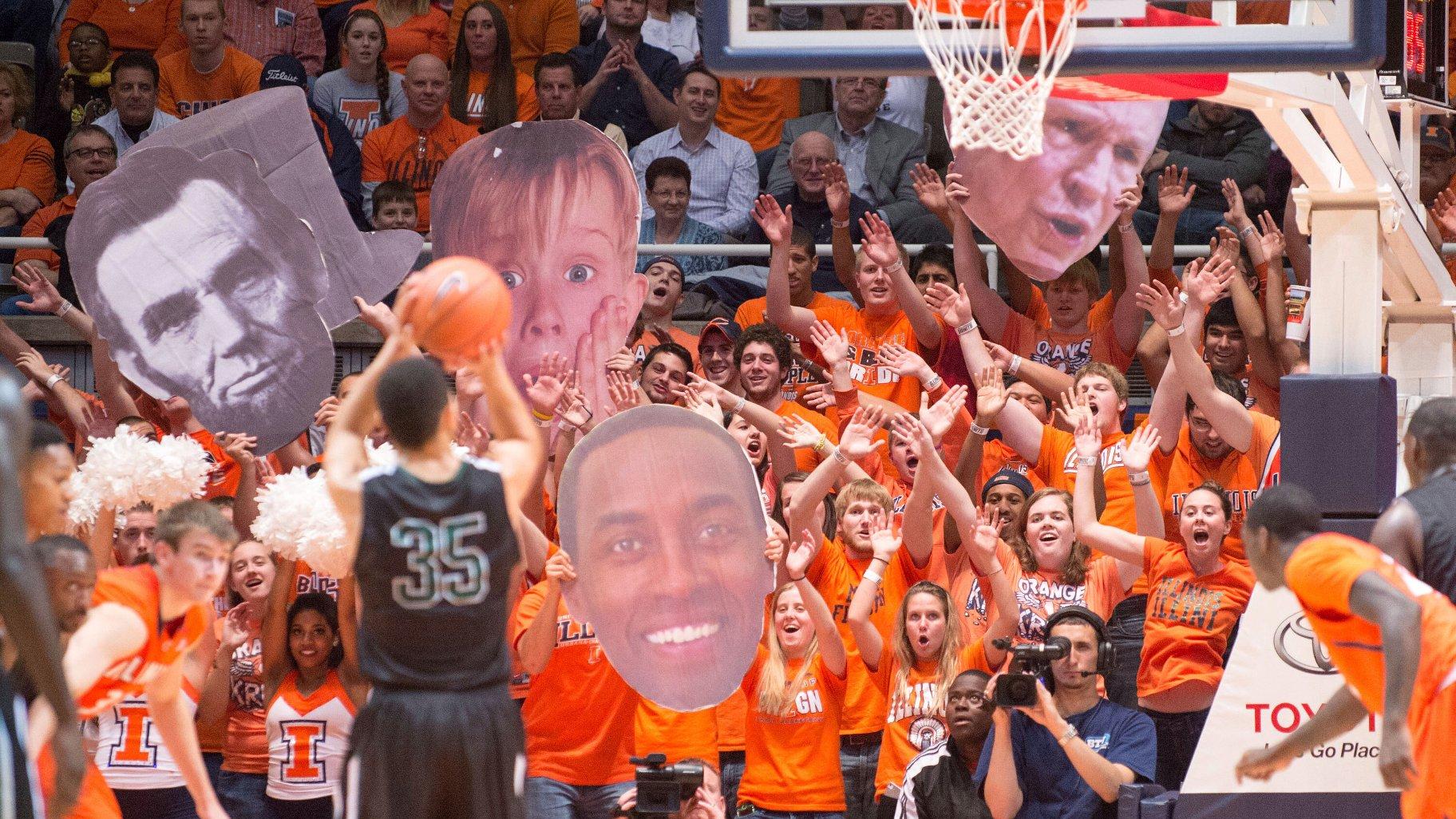 The Illinois Orange Krush student section uses large heads to heckle Chicago State's Clarke Rosenberg (35) as he tries for a foul shot during the second half of an NCAA college basketball game on Nov. 22, 2013, in Champaign, Ill. (AP Photo / Darrell Hoemann, File)