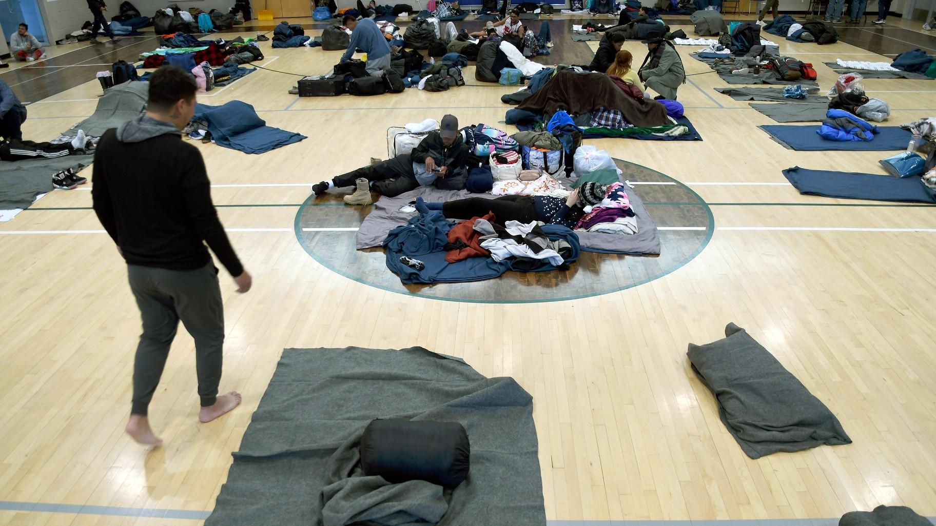 Migrants rest at a makeshift shelter in Denver, Jan. 6, 2023. Five mayors from around the U.S. want a meeting with President Joe Biden to ask for help controlling the continued arrival of large groups of migrants to their cities. (AP Photo / Thomas Peipert)
