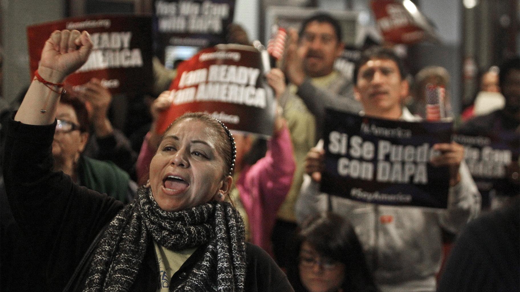 FILE - In this Tuesday, Feb. 17, 2015 file photo, Mercedes Herrera and others chant during an event on DACA and DAPA Immigration Relief at the Houston International Trade Center in Houston. (Melissa Phillip / Houston Chronicle via AP, File)