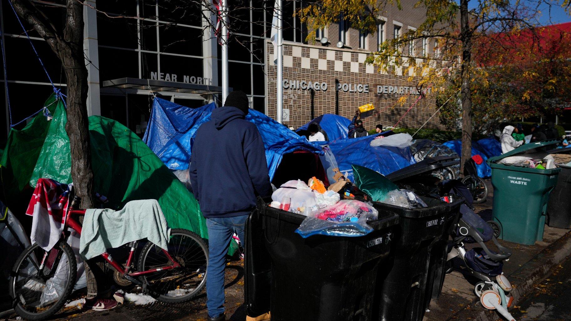  A man walks through a small tent community for migrants, Wednesday, Nov. 1, 2023, near a North Side police station in Chicago. (AP Photo / Charles Rex Arbogast, File)
