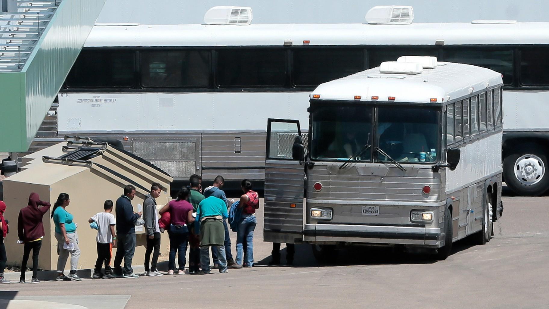 In this April 20, 2019 file photo, migrants are loaded onto a bus at the Border Patrol headquarters on Hondo Pass, in El Paso, Texas. (Mark Lambie / The El Paso Times via AP, File)