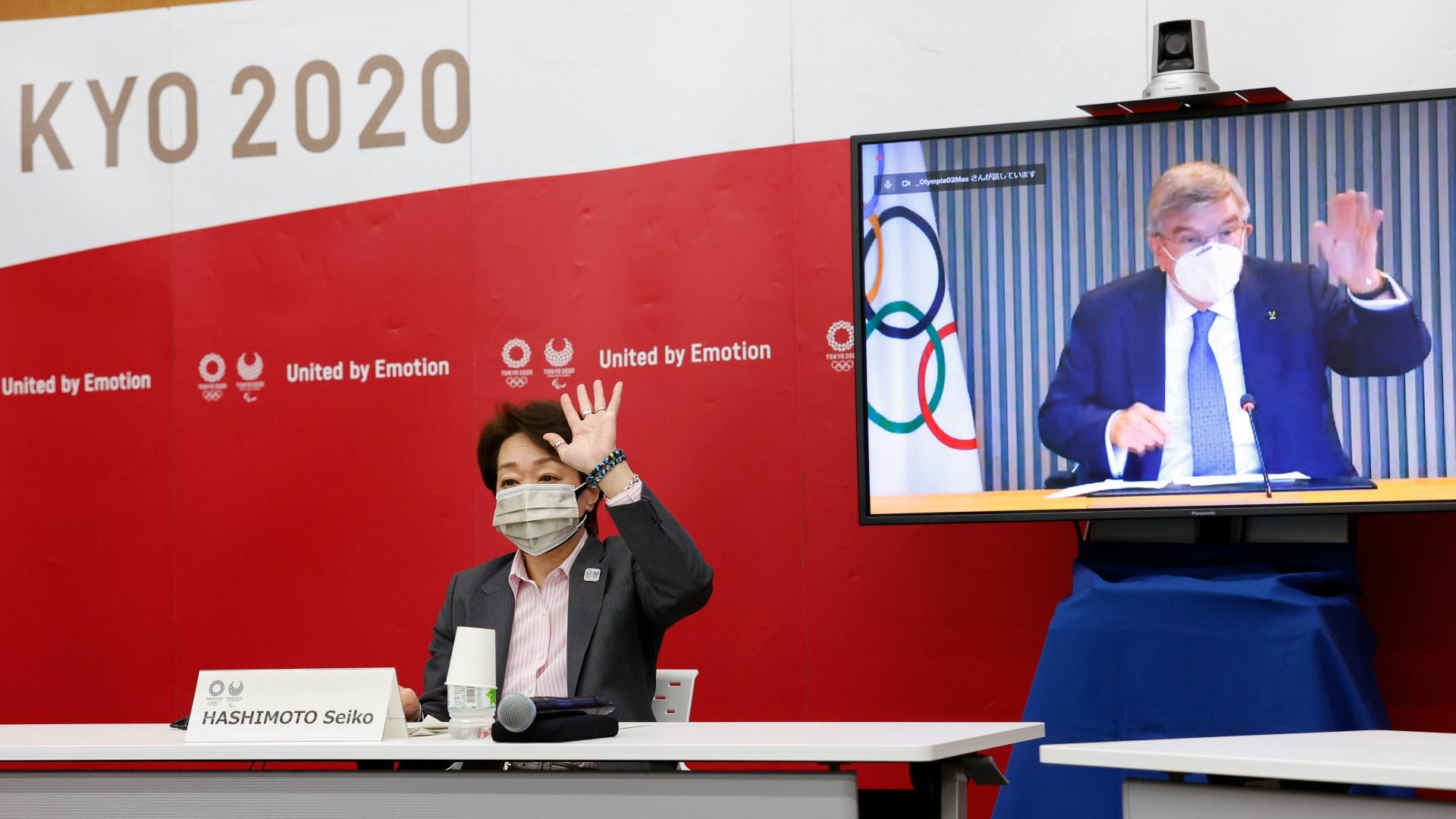 Tokyo 2020 President Seiko Hashimoto and IOC President Thomas Bach, on a screen, greet each other during a five-party online meeting at Harumi Island Triton Square Tower Y in Tokyo Monday, June 21, 2021. (Rodrigo Reyes Marin / Pool Photo via AP)