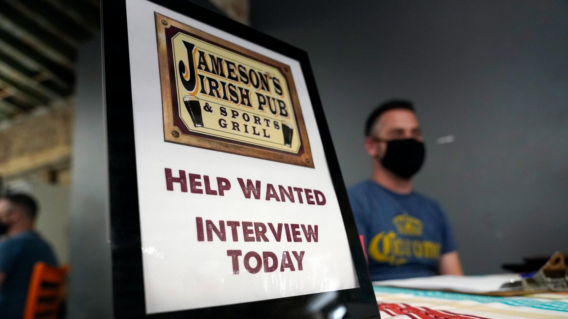 A hiring sign is placed at a booth for Jameson's Irish Pub during a job fair Wednesday, Sept. 22, 2021, in the West Hollywood section of Los Angeles. (AP Photo / Marcio Jose Sanchez, File)