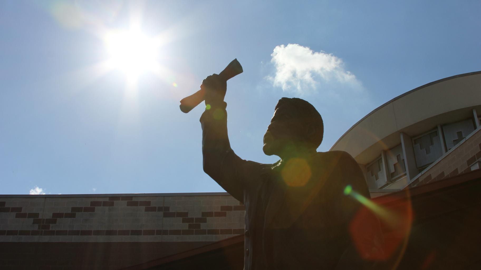 A bronze sculpture by Eddie Dixon is one of five sculptures representing the story of Juneteeth at the George Washington Carver Museum in Austin, Texas. (Jennifer M. Rangubphai / Wikimedia Commons)