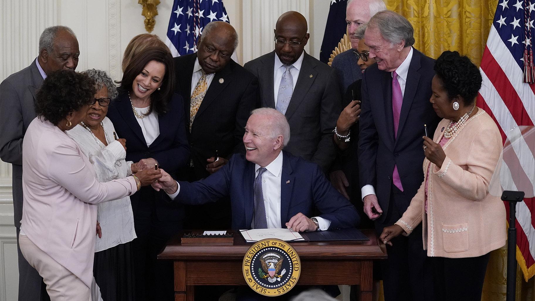FILE - In this June 17, 2021, file photo, President Joe Biden hands a pen to Rep. Barbara Lee, D-Calif., after signing the Juneteenth National Independence Day Act, in the East Room of the White House in Washington. (AP Photo / Evan Vucci, File)