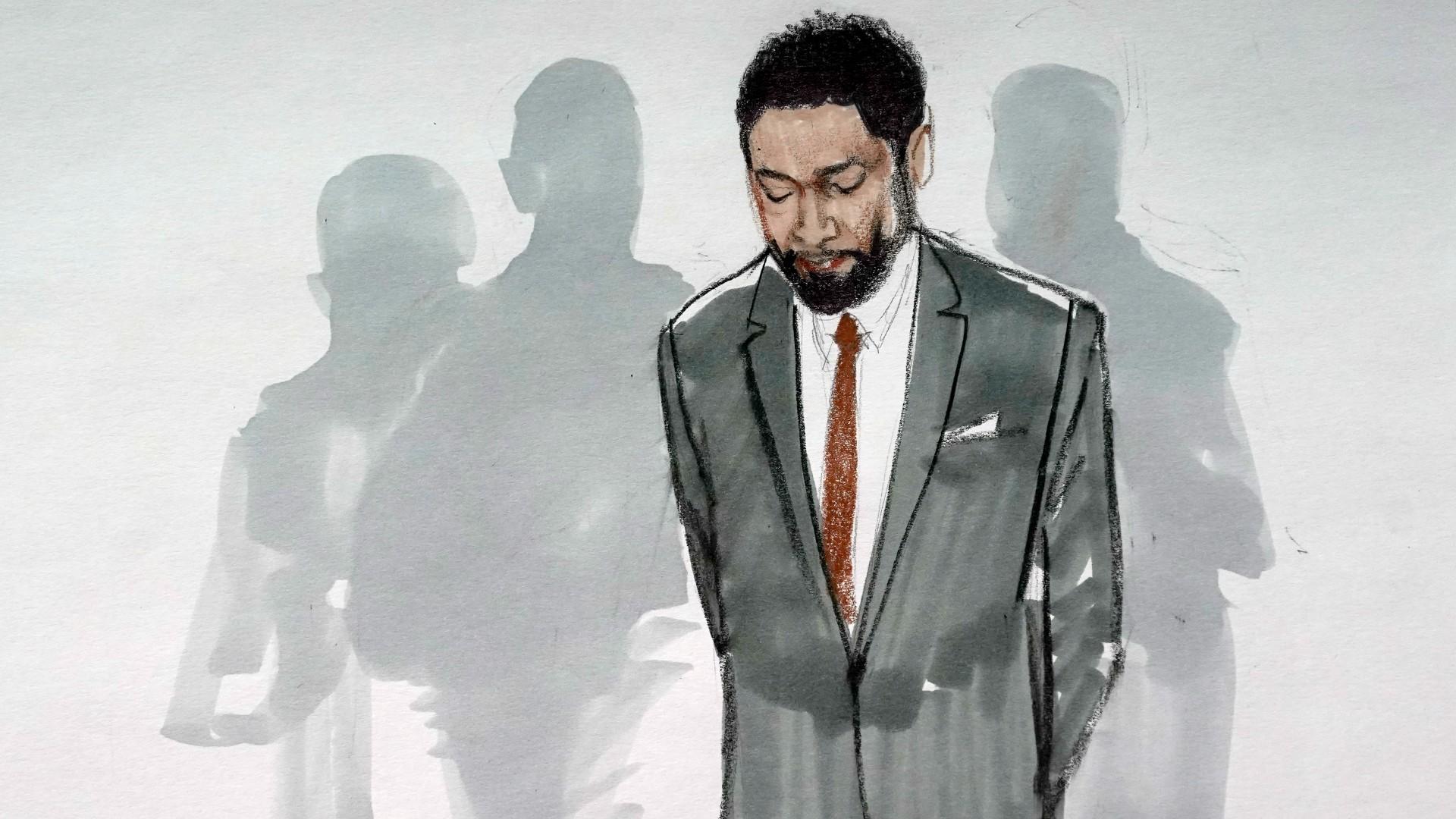 In this courtroom sketch, actor Jussie Smollett stands with his legal team in a Leighton Criminal Courthouse courtroom, Thursday, Dec. 9, 2021, in Chicago, after a jury found him guilty on five of six charges he staged a racist, anti-gay attack on himself and lied to police about it. (AP Photo / Cheryl Cook)