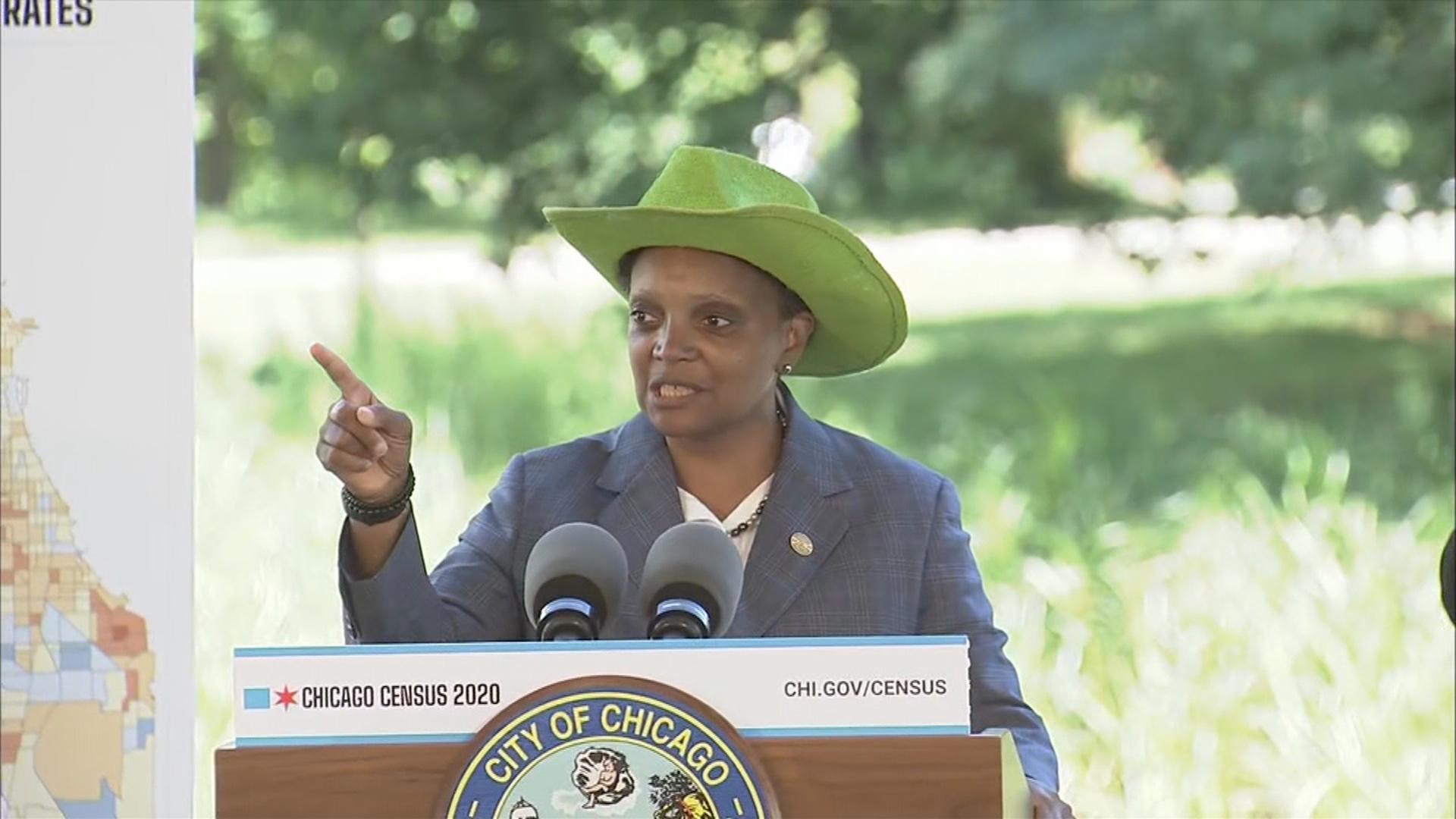 Mayor Lori Lightfoot dons a bright green cowboy hat before introducing a special guest — and his 13-year-old horse — at a press conference Monday, July 13, 2020. (WTTW News)