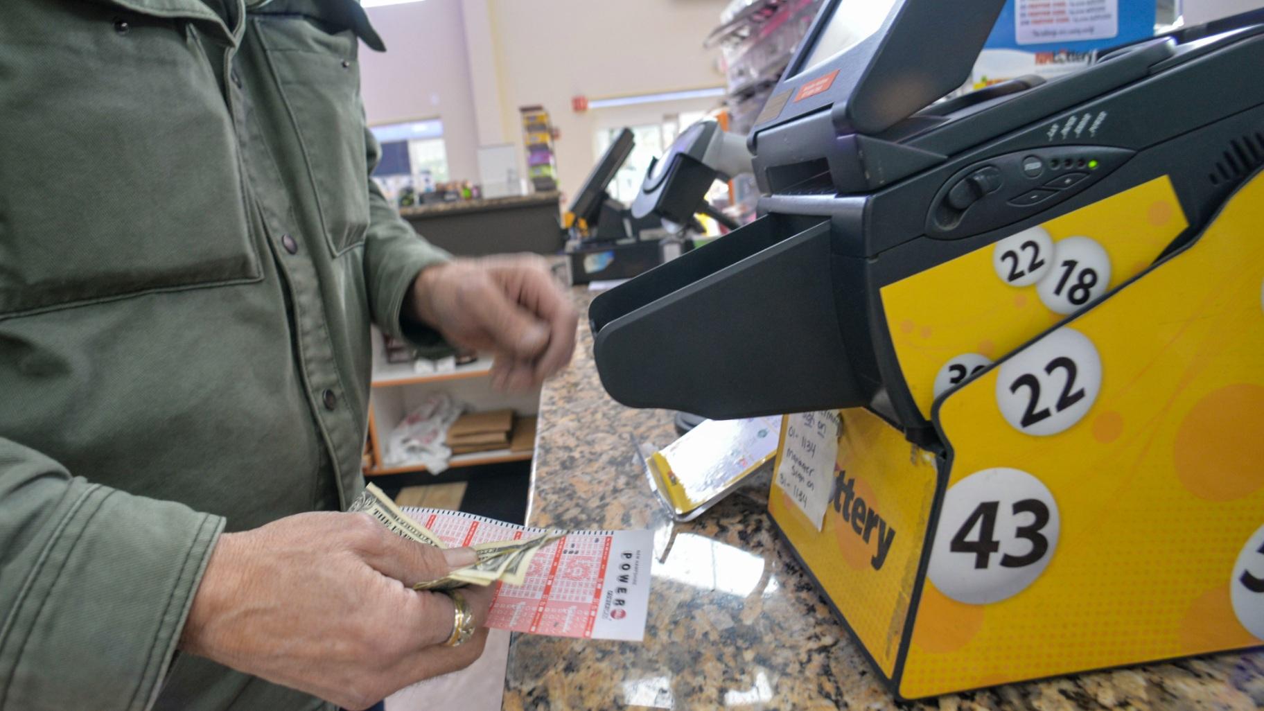 Bruce Gideos, floor manager at Pierre’s Place, in Chesterfield, N.H., prints out Powerball tickets on Thursday, Nov. 3, 2022. (Kristopher Radder / The Brattleboro Reformer via AP)